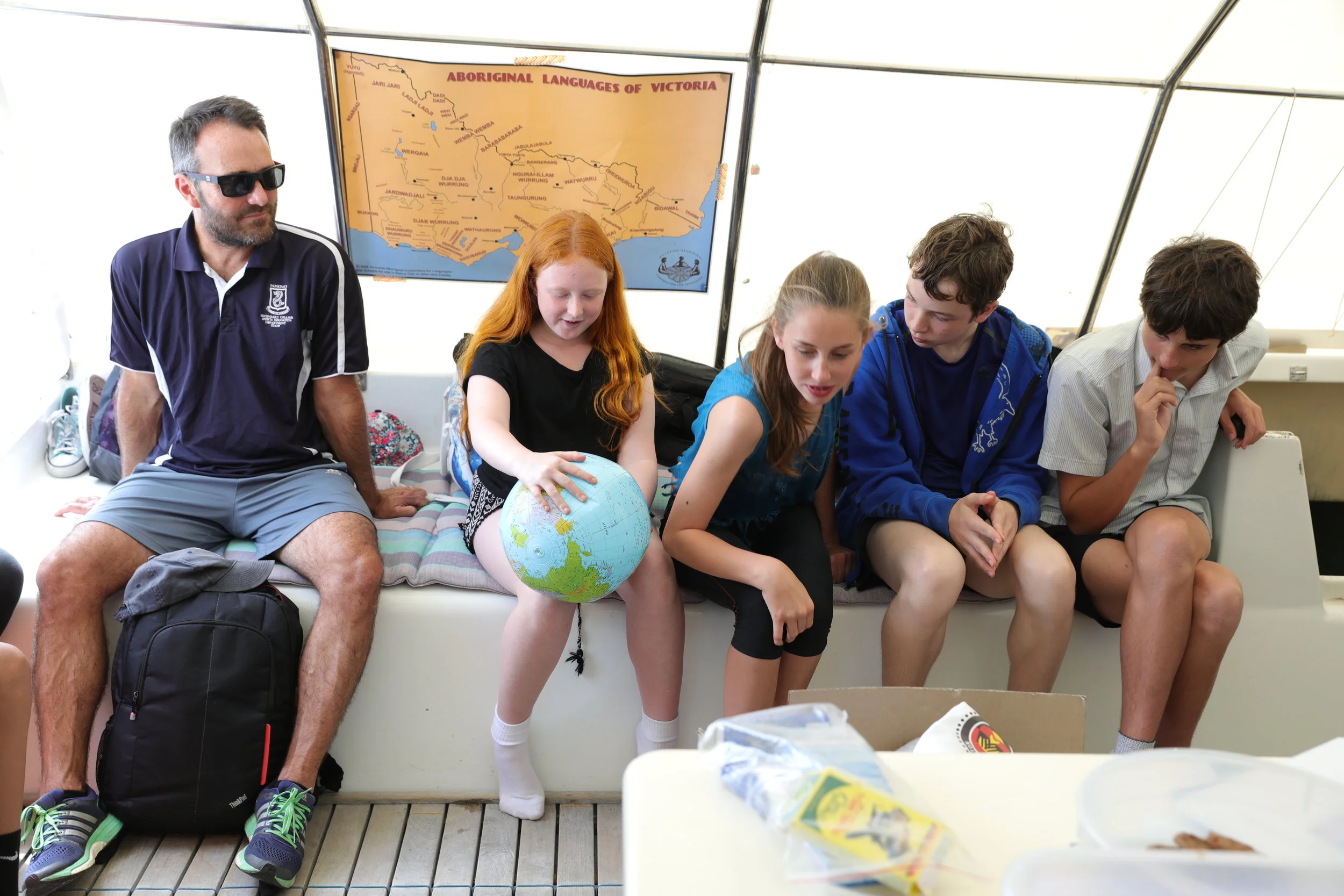 Young students learning that Earth should perhaps be called Ocean as over 70% of the planet is covered in water.