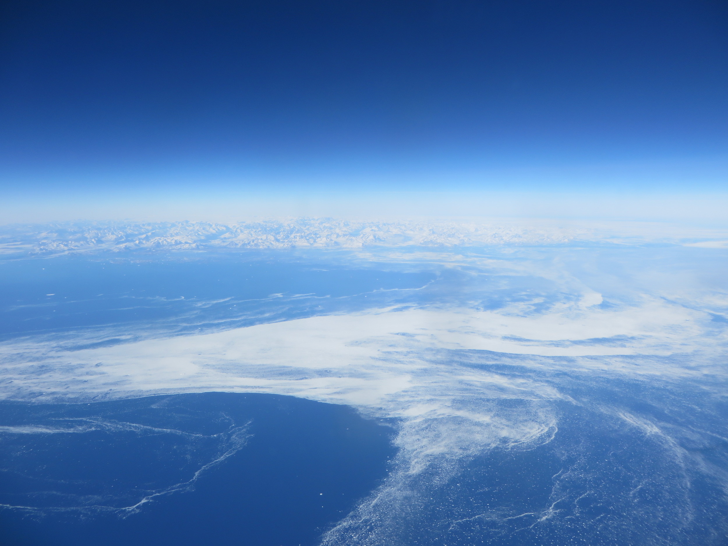 Flying over Greenland on the way home. The white stuff is sea ice.