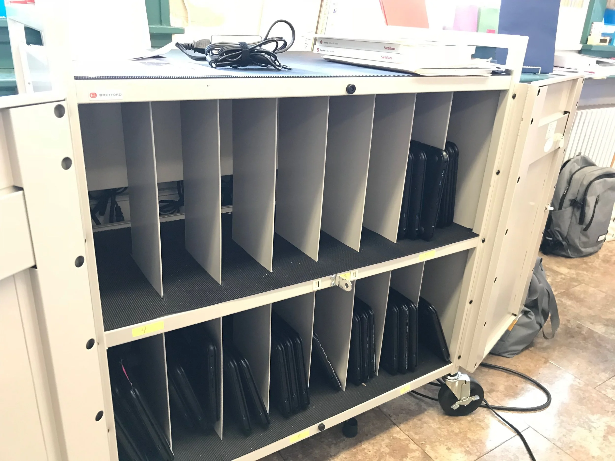 This one cart has 16 slots (for those 16 plugs in the back), but even if you crammed three chrome books to a slot, and somehow macgyvered the charging adapters to charge those crammed chrome books you'd still only be charging 48 of the 64 total chrome books! 
