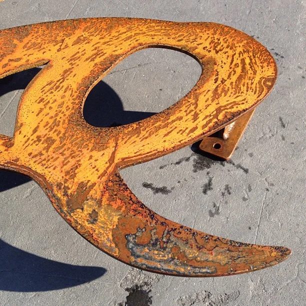  Applying patina to the sign. 