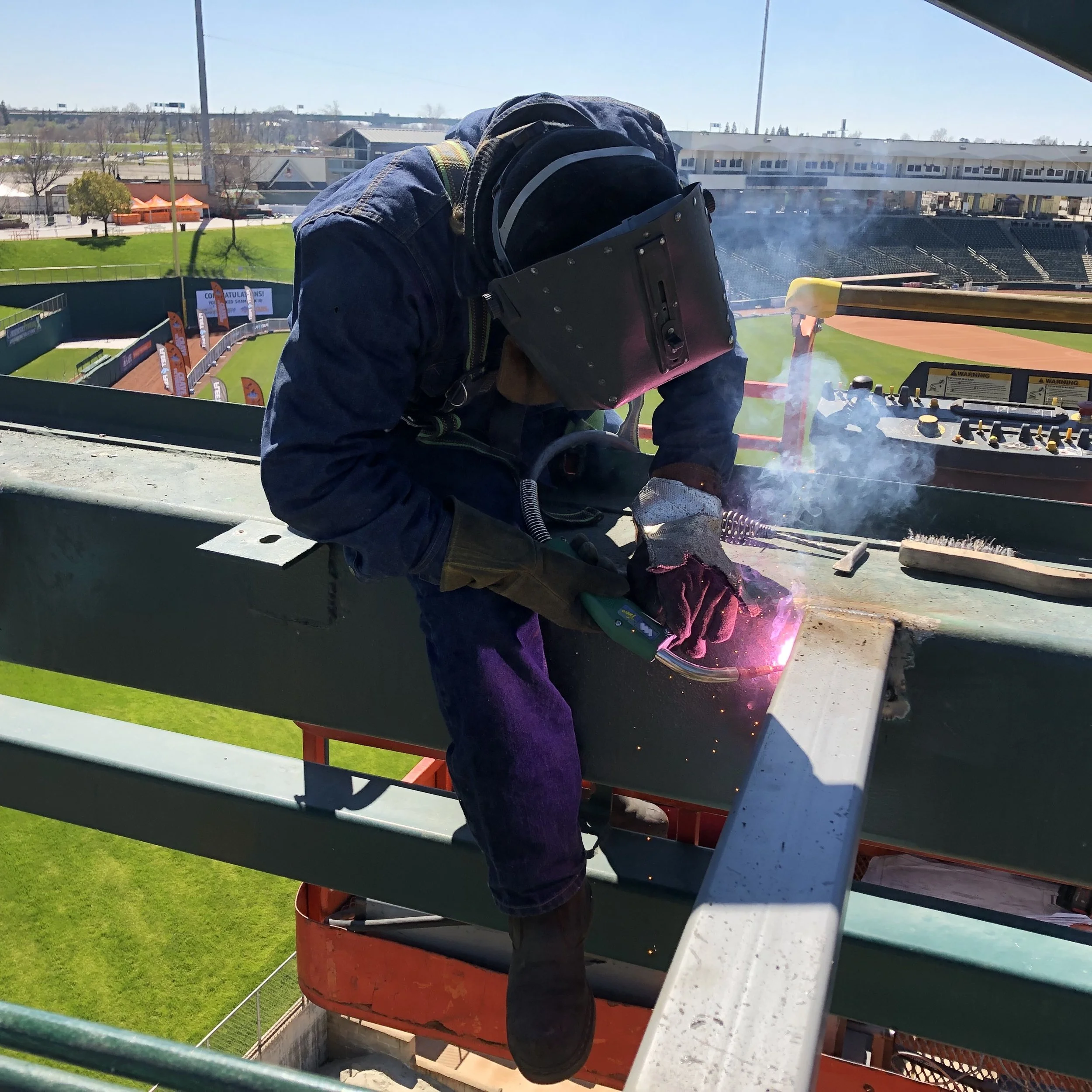 Kasdan welding structural cross-members in the Raley Field Scoreboard Tower.