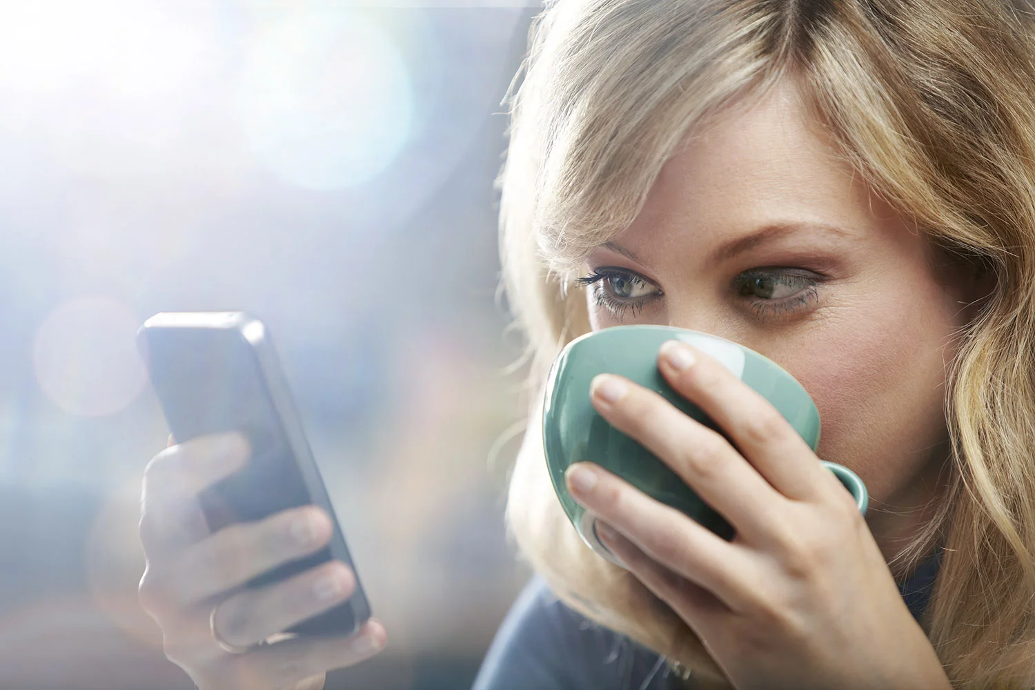 Woman using mobile phone to view website