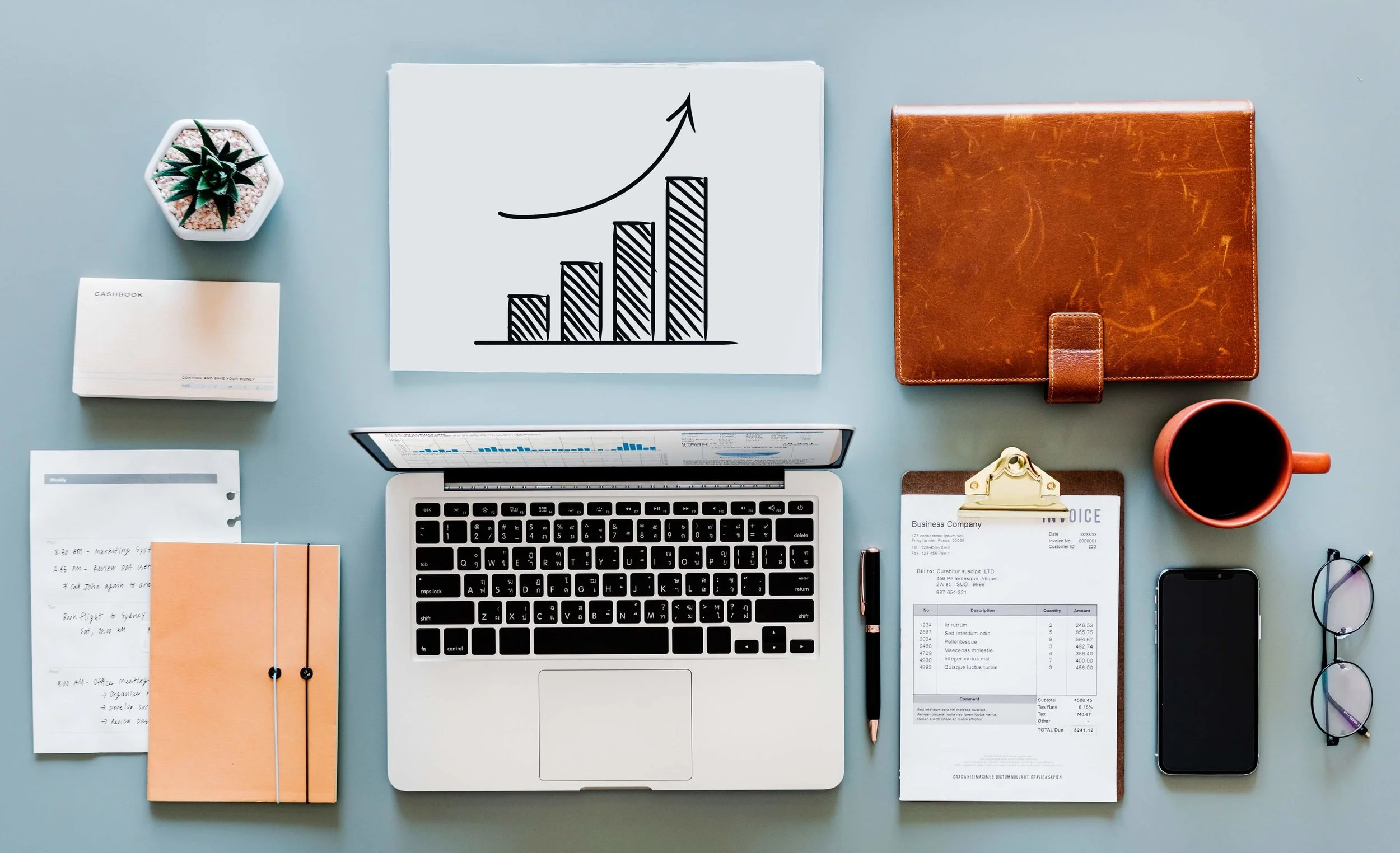 Website Design - Visual Hierarchies shown with physical objects beside laptop