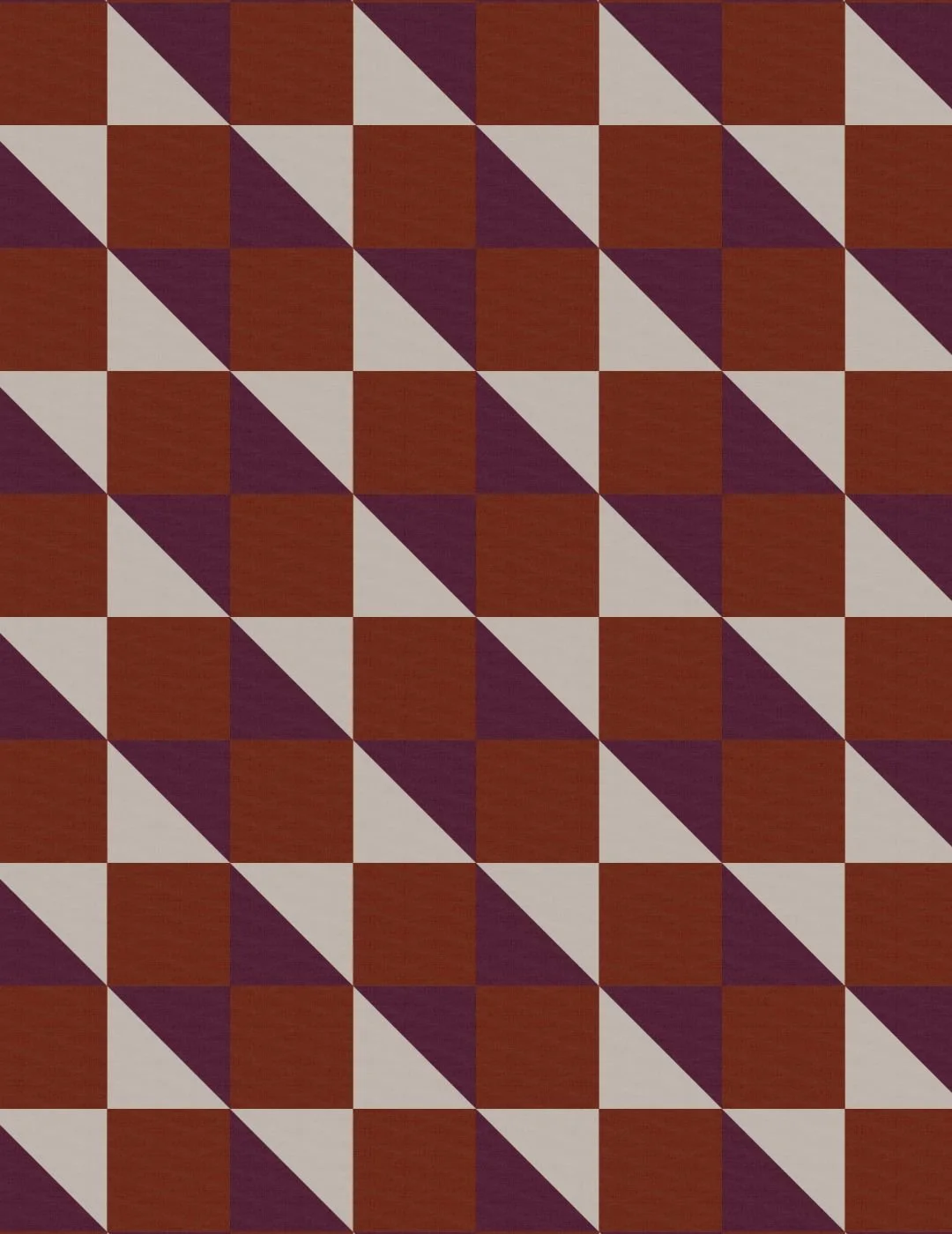 A geometric quilt block pattern of alternating dark plum and gray triangles, forming diagonal lines across a rust brown background, creating a bold, dynamic design.
