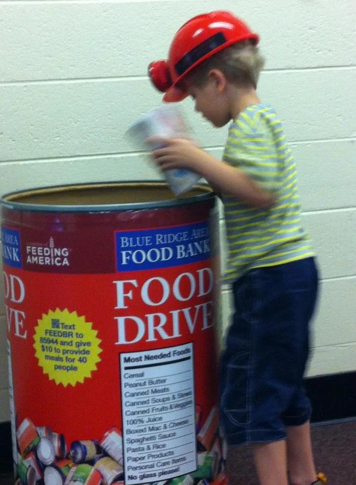 An attendee donating to the food bank at our 2013 Gordon Avenue Library show in Charlottesville. 