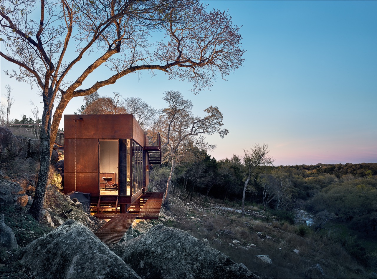 CLEAR ROCK RANCH 2017 AIA Austin Design Award Winner Clear Rock Lookout is a raw steel hunting blind, writing studio, and observation deck that celebrates the stunning landscape and wildlife views. The 450sf building is nestled below a limestone cliff edge, and has to be “discovered” when approached from the top of the mesa. This gradual reveal of the building strengthens the unfolding landscape panorama made possible from the unique vantage provided by the structure. The site was specifically chosen for its views by the owner after years of slowly traversing and mapping the wooded cliff edge. The modern form contrasts with the Hill Country vernacular used on the rest of the 1,000 acre West Texas ranch. Naturally weathering steel was chosen to age with the surroundings and to pay homage to the owner’s youth spent welding oil tanks. Large sheets of glass, a variety of warm woods, and a highly detailed assembly complete the “jewelbox in the landscape” expression of the lookout. Contractor: Ron Reue Construction Steel Fabrication : Longhorn Welding Structural Engineers : Arch Consulting Engineers Photo Credits : Casey Dunn Publications: Dezeen