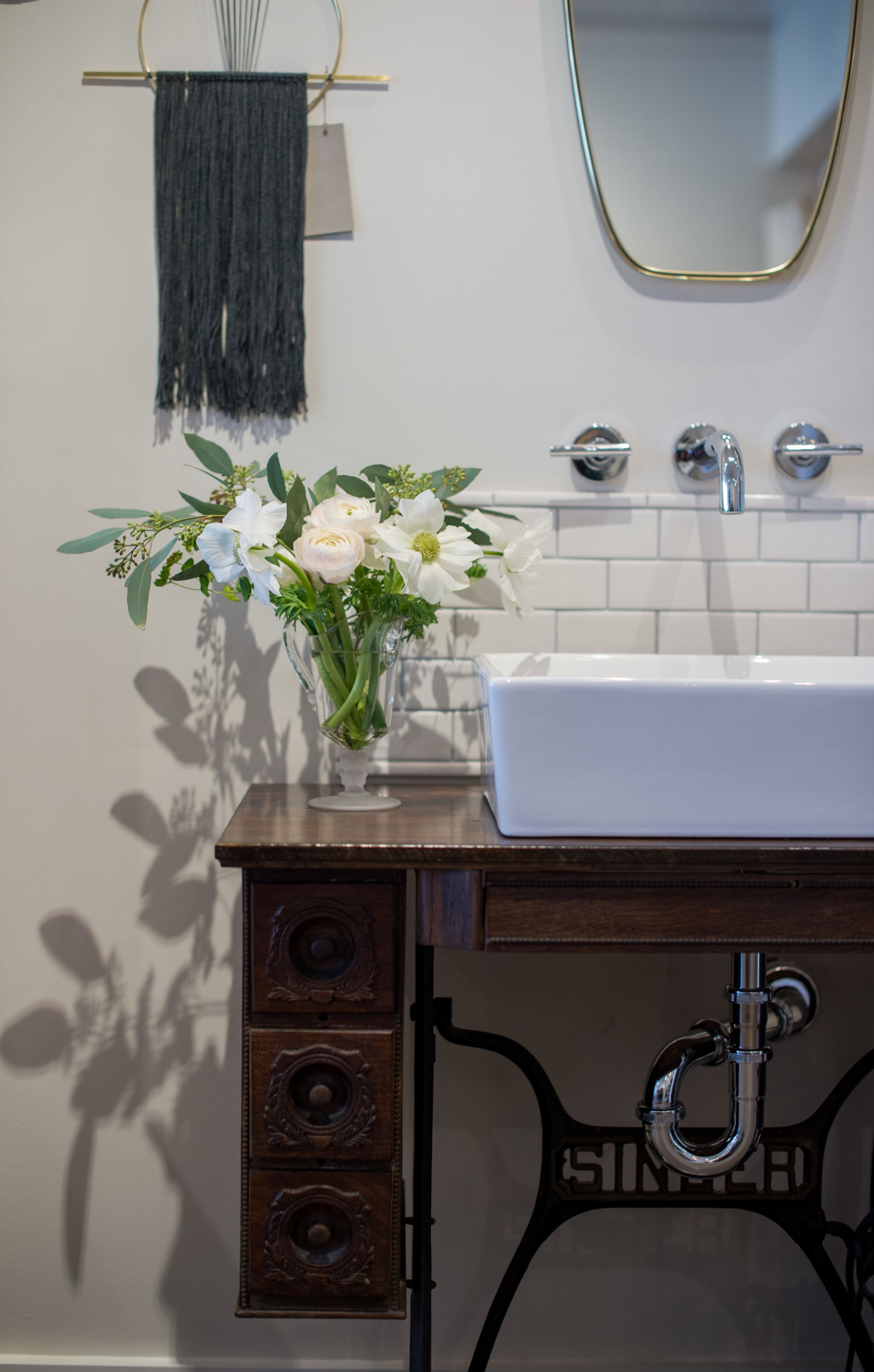 This Singer sewing machine table belonged to the shop owner's grandmother and made for the perfect wash basin for soaps and cosmetics.