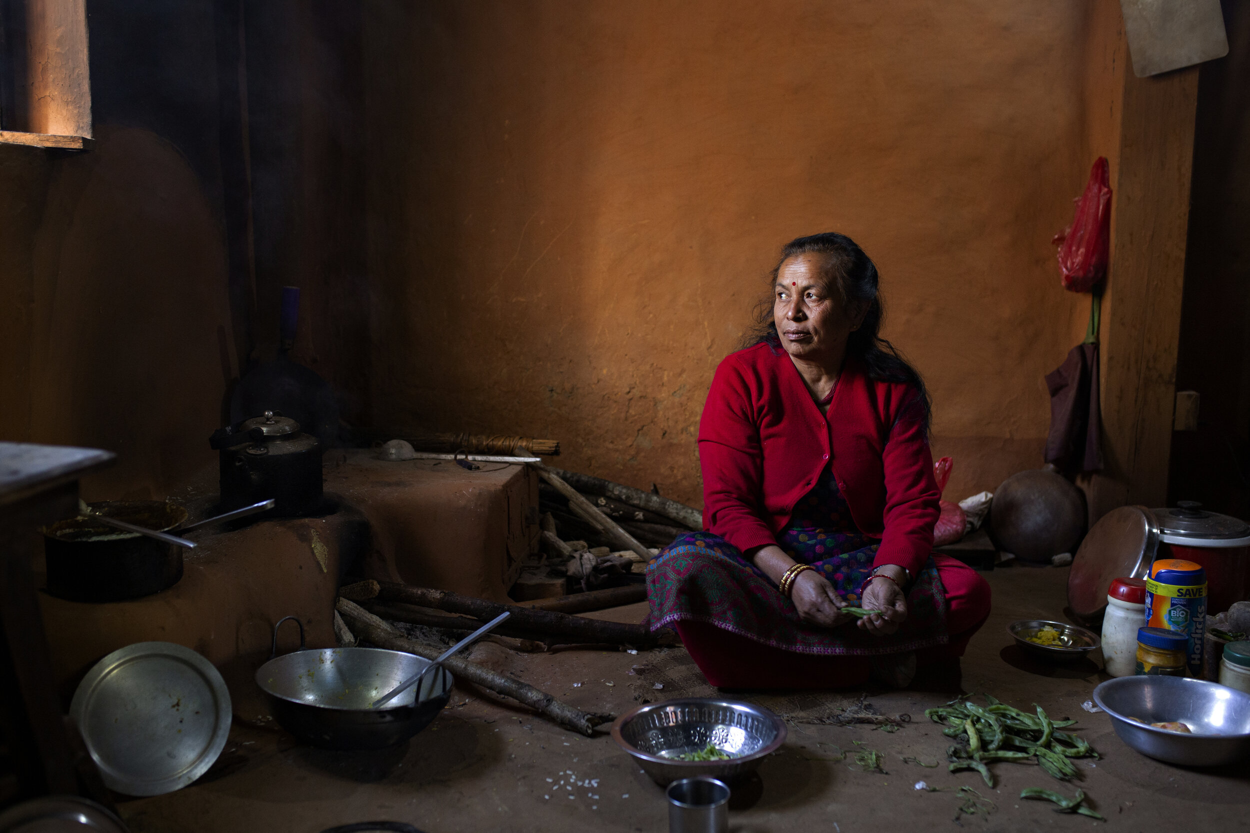   Ama , meaning mother in Nepali, prepares lunch in her home in Rayale.  