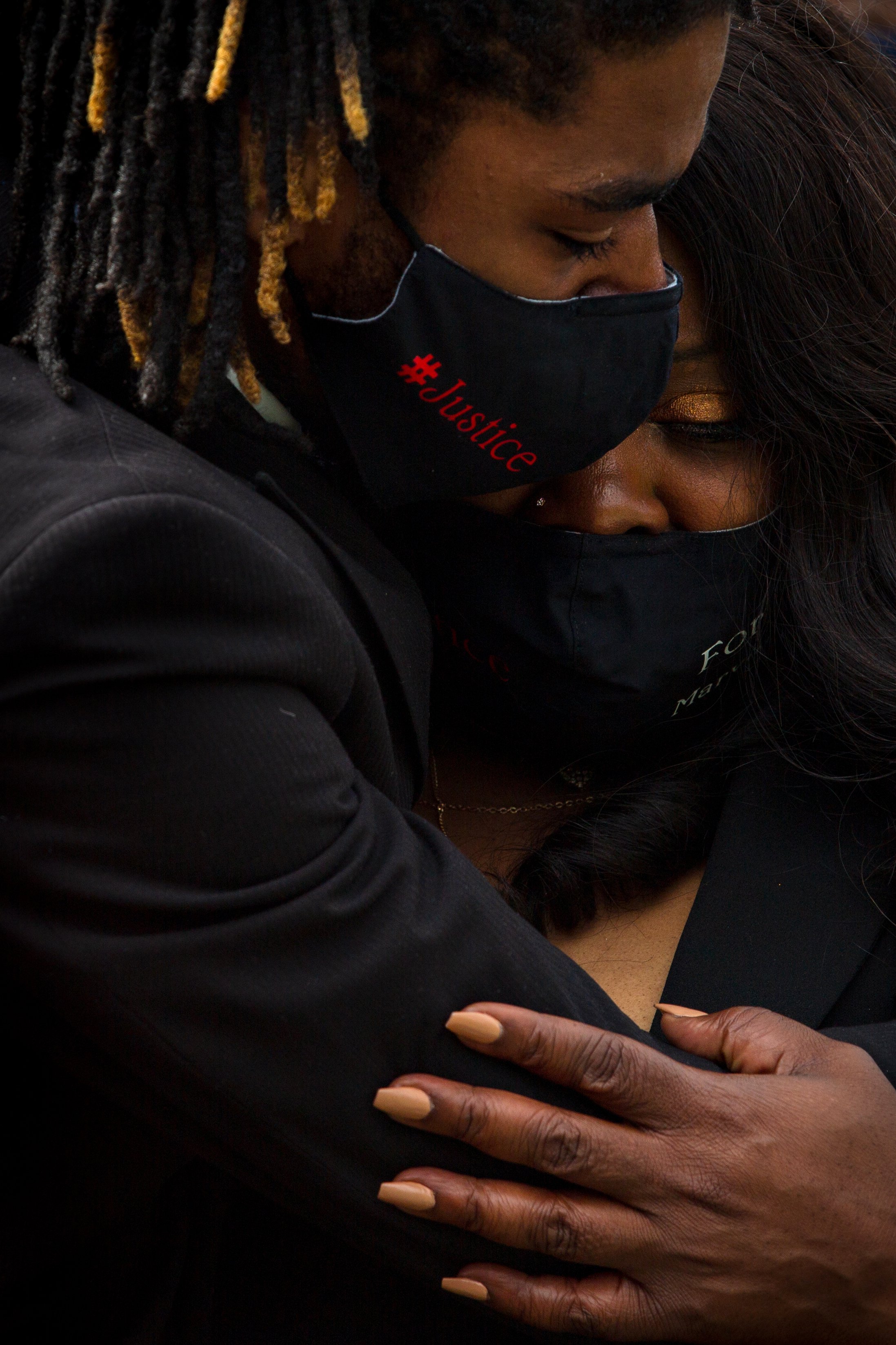  Quinten Scott holds his mother LaSandra Scott as they mourn his brother and her son, Marvin Scott III, at his funeral in his hometown of St. Louis, Missouri on March 30, 2021. 