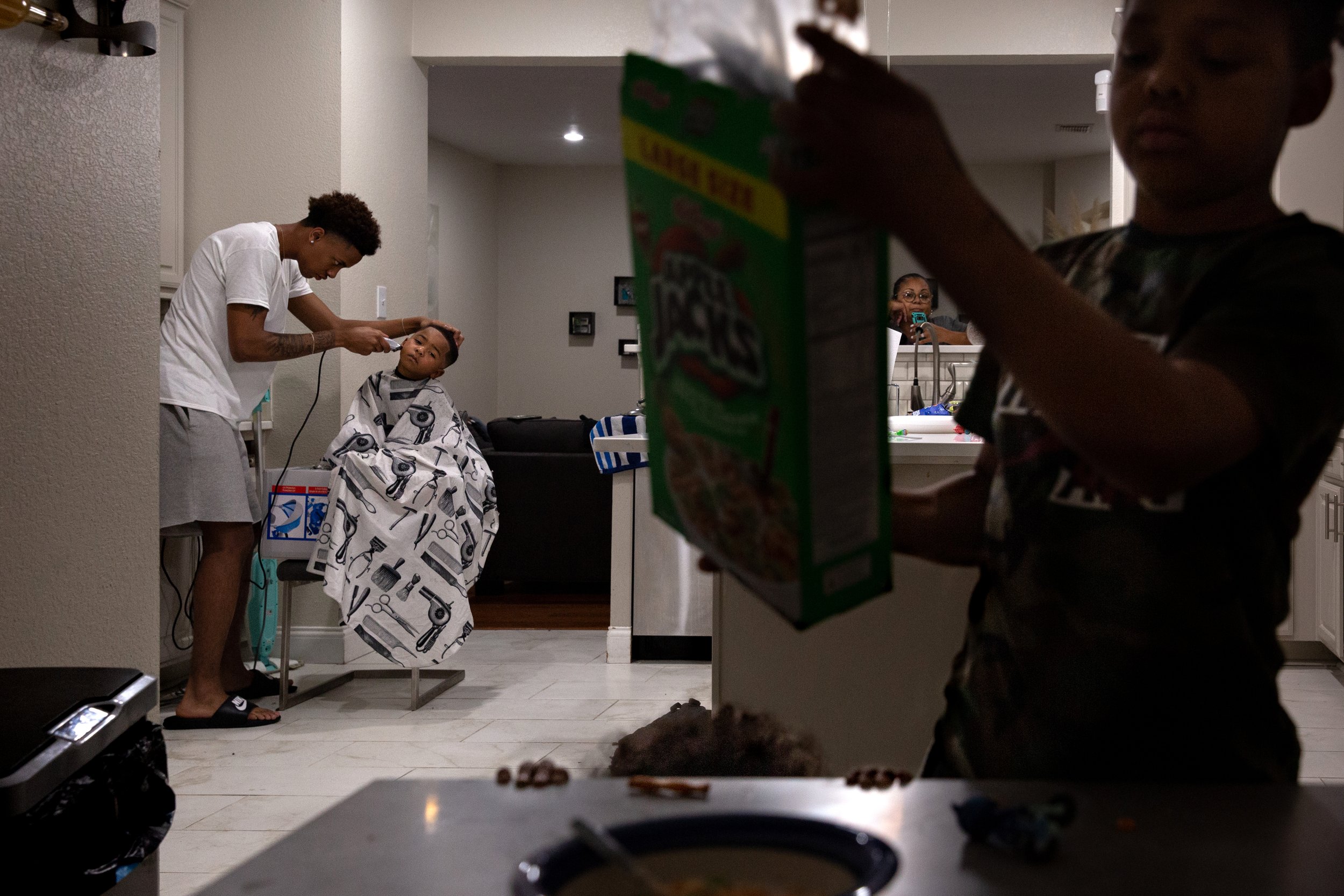  LaChay’s children Rylan and Elijah get their hair cut and snack as they wait for their mother to finish a zoom meeting. The Scott family and community members would meet at the jail every night to demand the arrest of the jailers involved in Marvin 