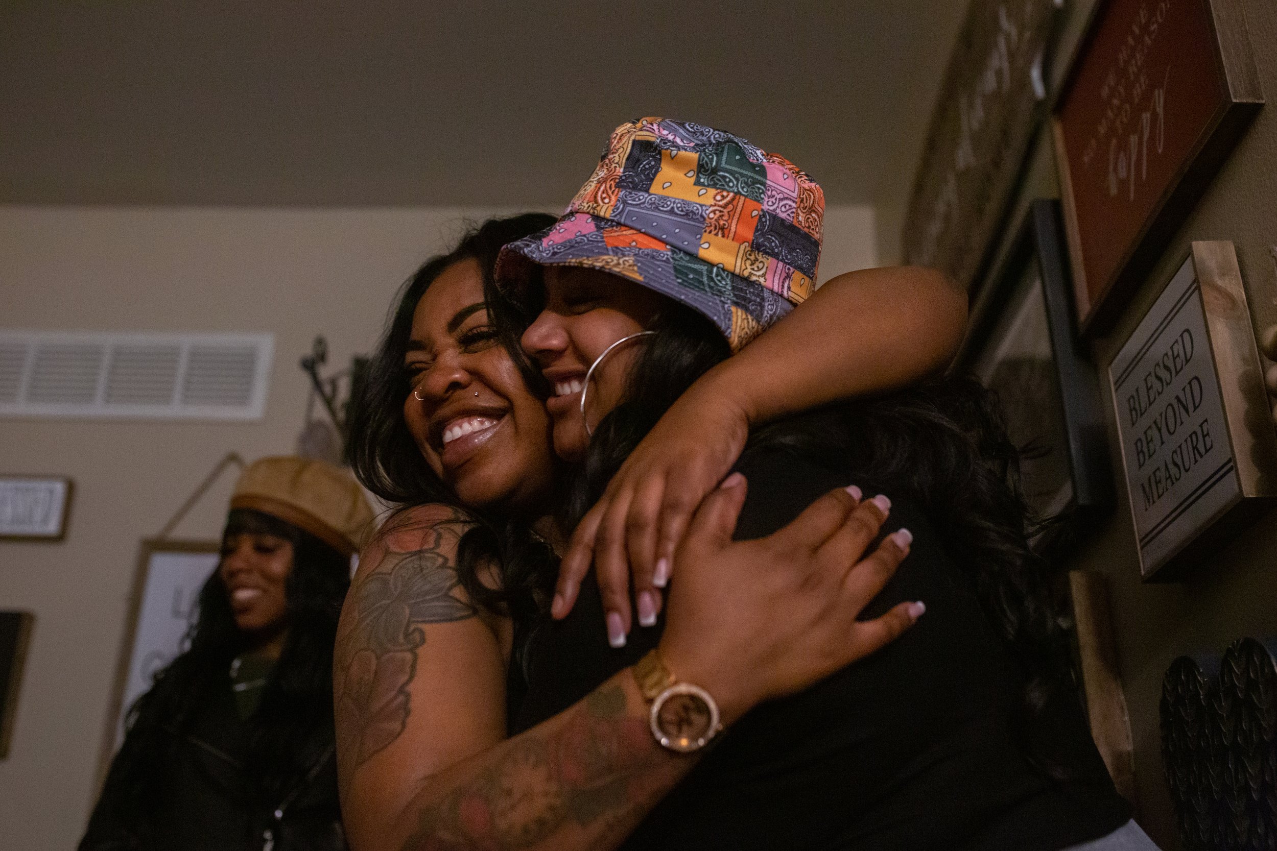  LaChay hugs her friend Brianna Ballard at a friend’s home in St. Louis the night of her brother’s funeral, March 30, 2021. Hometown friends and family came together with those traveling from Texas to support and bring some moments of joy to the fami