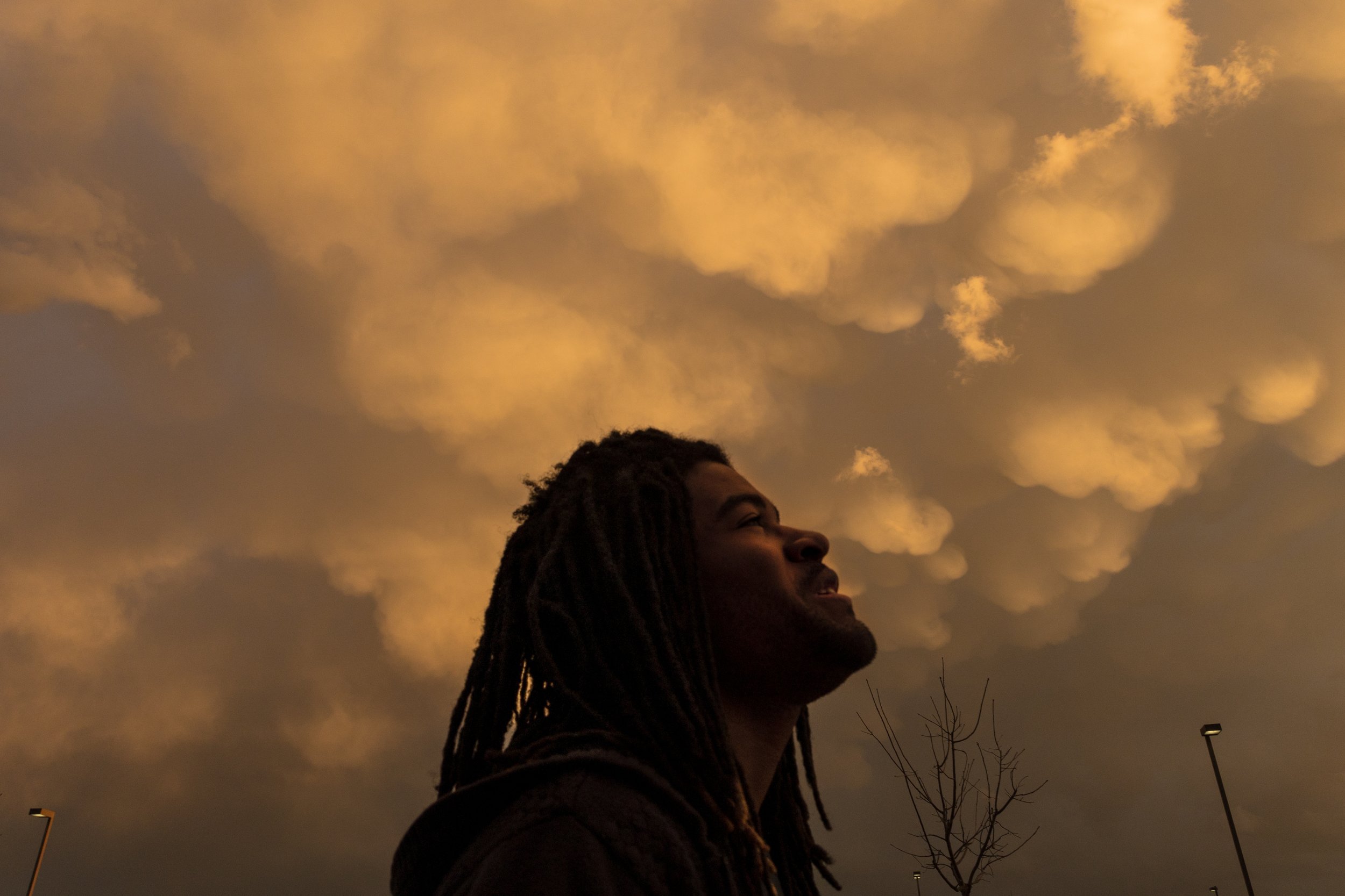  Quinten Scott looks up into the sky before a vigil is held for his brother Marvin Scott III at the Collin County Jail, where Marvin died one year ago. “This is maybe the second time in my life that I’ve seen a rainbow,” says Quinten as the anticipat