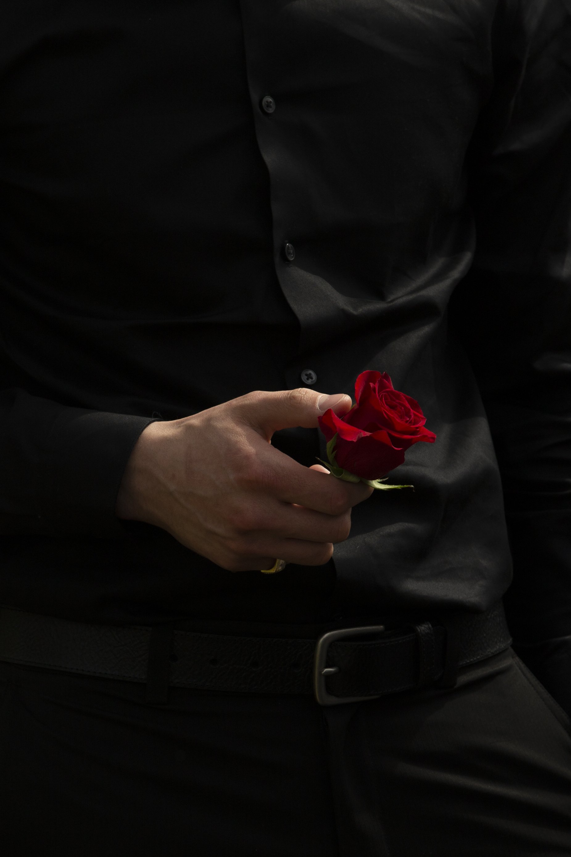  Hussein Azab, one of Marvin’s best friends, holds a rose at his funeral. 