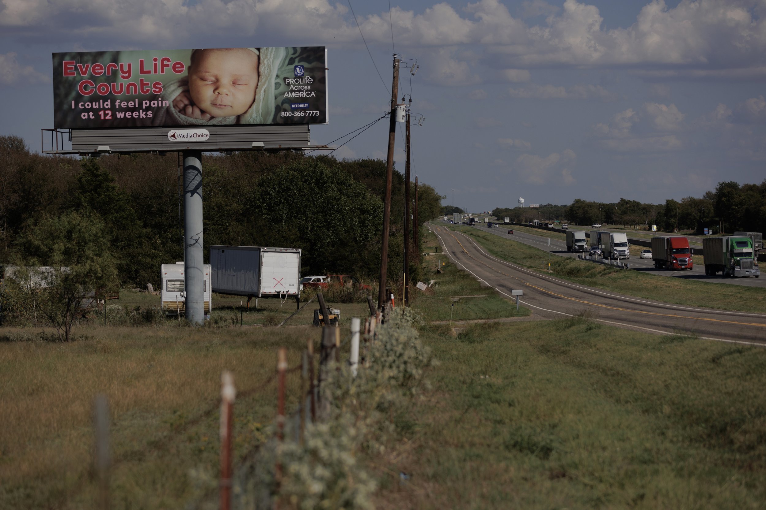  A pro-life billboard alongside the I-30 highway. Every week, Miranda traveled from New Boston to Dallas for doctors’ appointments. Early on, she looked forward to these trips, sure her doctors would find a solution, but by the end, she forced hersel