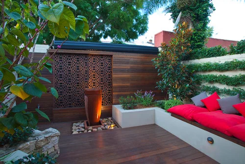 Another way to add a different feel to your backyard room is by adding an eye-catching centerpiece. This trick of the eye allows your space to look much larger. Another way this can be done is by incorporating pieces of art or sculptures into the backyard design. Image as seen on huffingtonpost.com