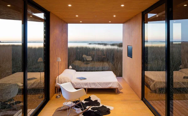 This tiny house was placed in the middle of a field overlooking a lake and really submerses you into the natural surroundings. Image as seen on homedit.com