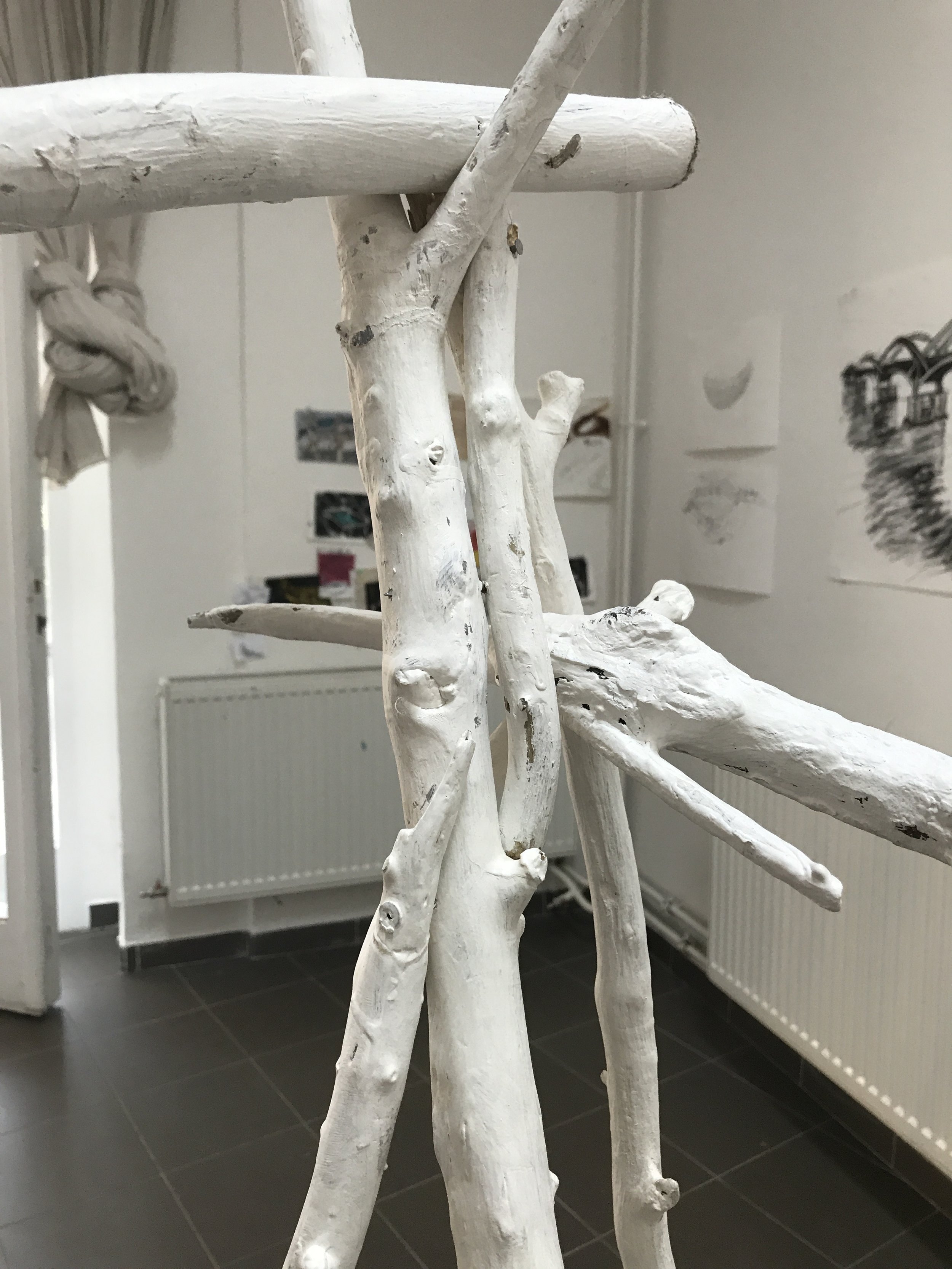 One of four boats made of driftwood and copper wire, each piece of wood burnished by hand. Three boats are suspended above the ‘river’ by thin wires from large natural wood tripods, which are painted white to more easily blend in the the gallery’s background. Installation is easily reconfigured to fit any space. If the background were a different color, the white stands should be painted to match it.