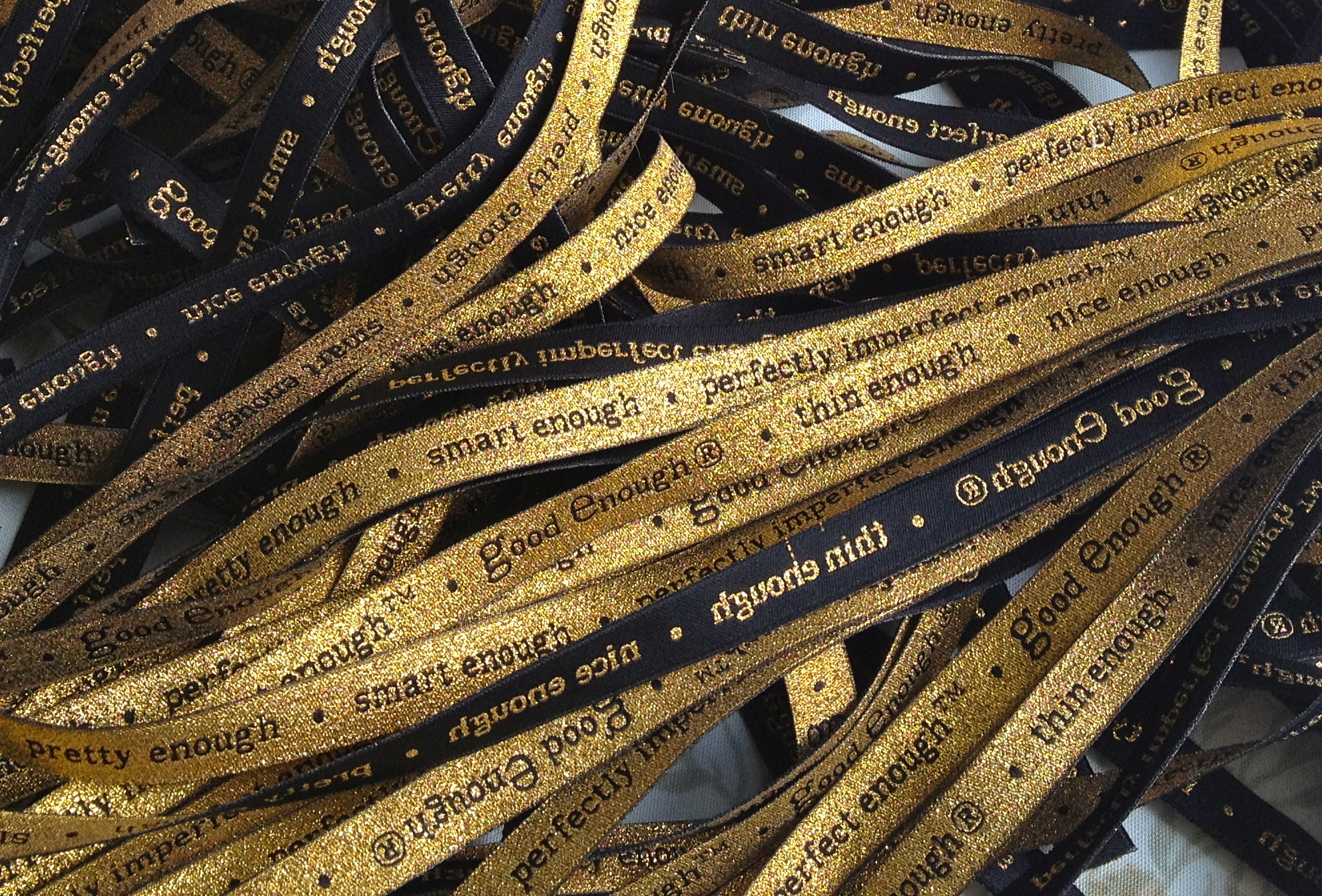 Our unique ribbon, sewn with care into every bag 