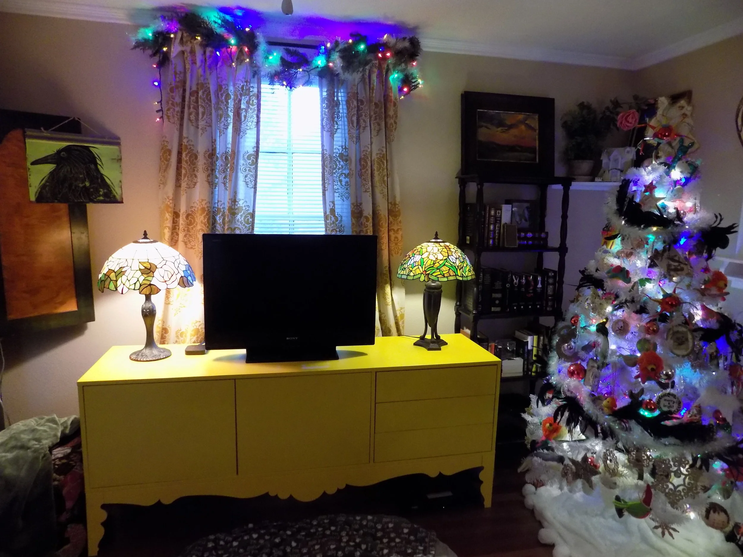 I found this amazzzingggg yellow console at IKEA in 2010, and I'm still in love.&nbsp; The landscape painting on the right side (above the tree) is one of my college sketches.