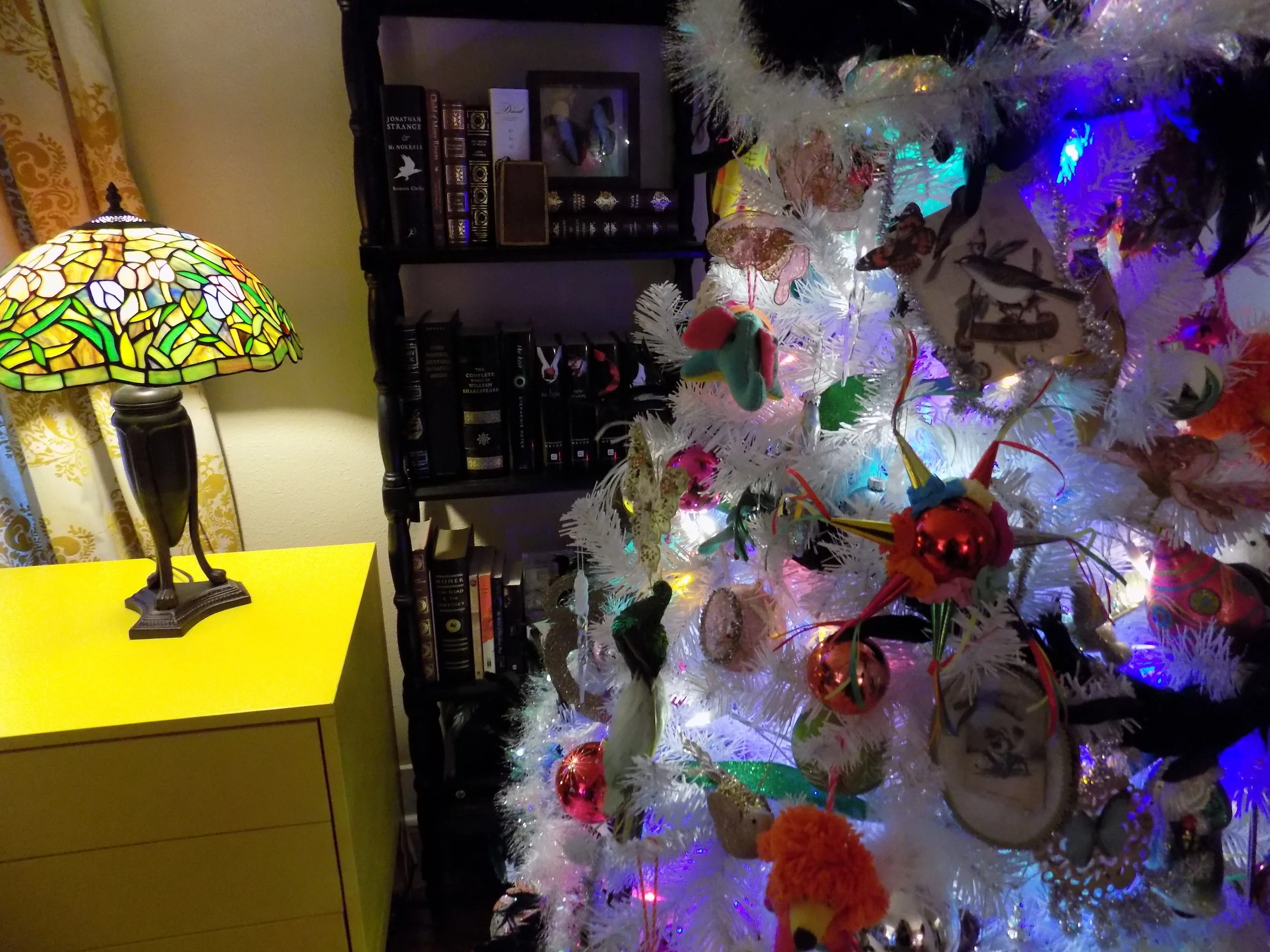 My ornaments are a mix of Victorian style pieces combined with bright felt creatures and glass orbs (Target).&nbsp; The feather garland is made from peacock feathers.