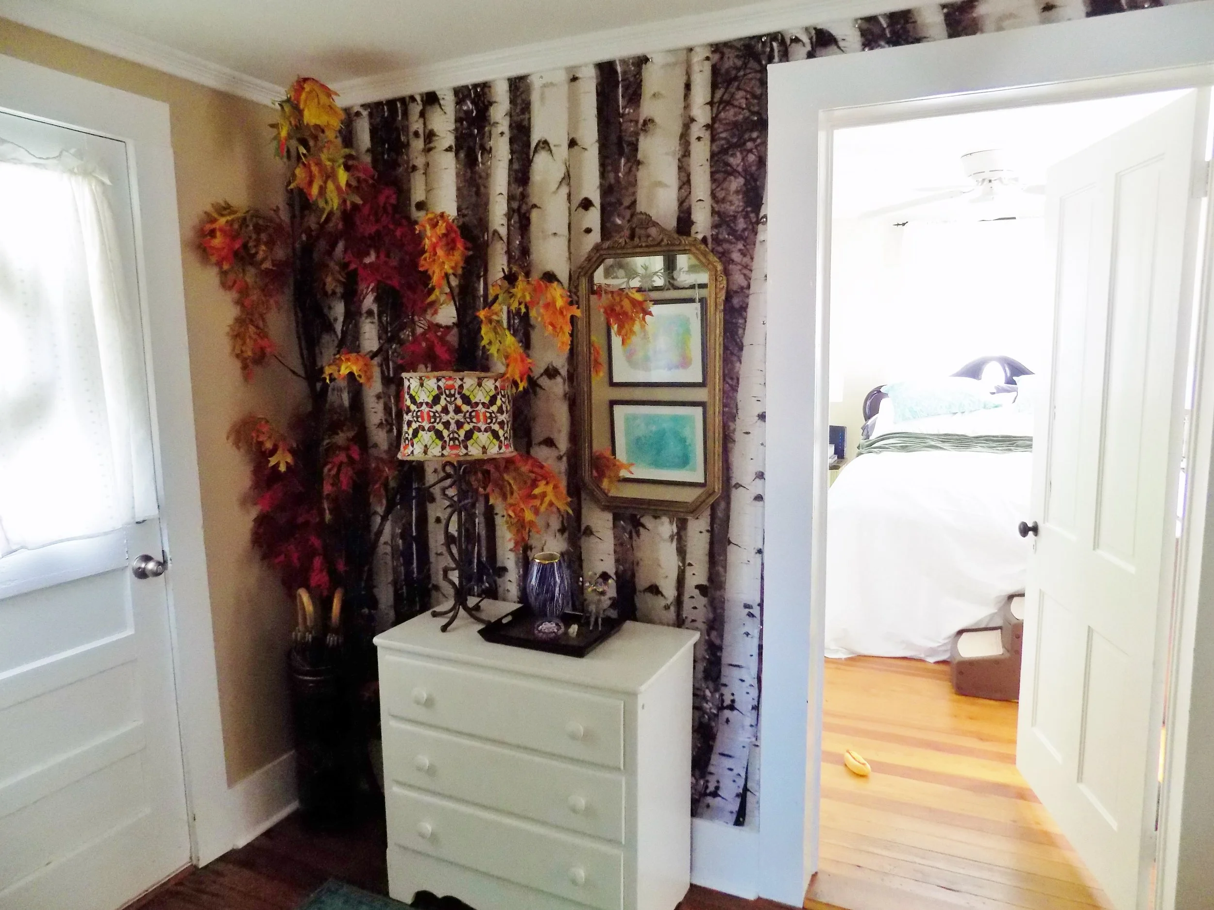  The front hallway is a birch forest! Says Lee "I created this fake autumn tree branch last fall for my Halloween Party decor and it ended up staying." The branch proves to be the perfect accent for the birch tree fabric Lee tacked to the wall. 
