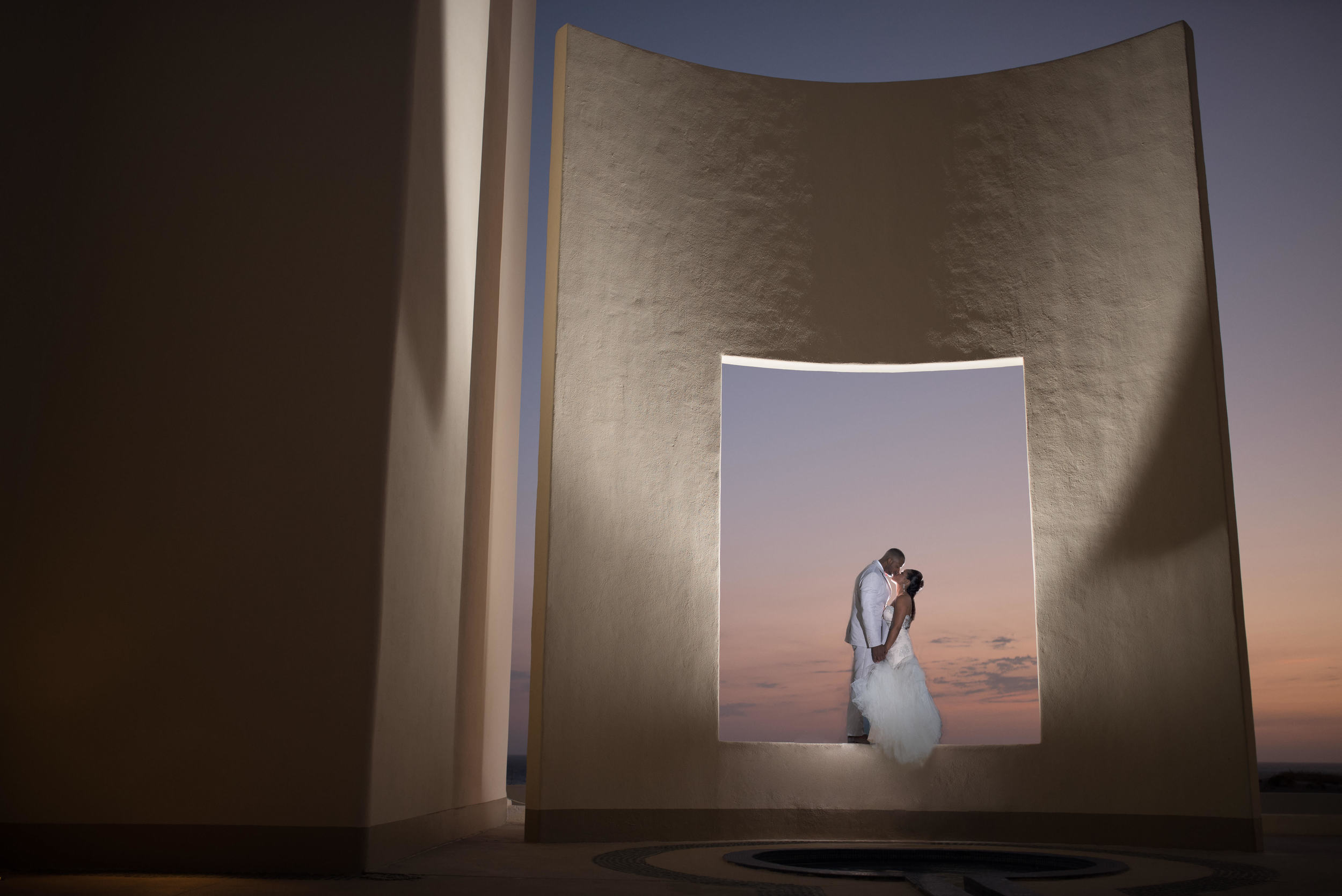 Bride and groom kissing at The Pacific Window at Pueblo Bonito Pacifica. Sunset session with talented GVphotographer