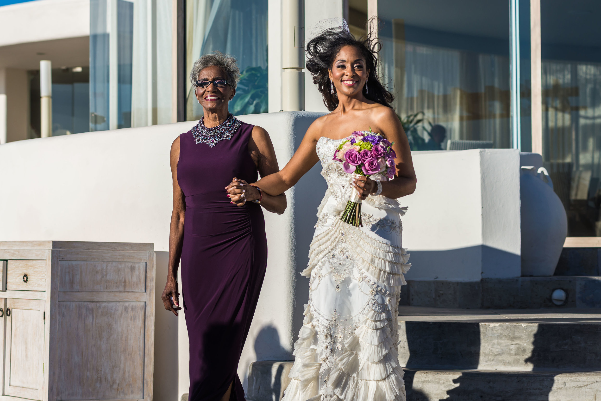  Bride walking to the aisle with her mother on her Cabo destination wedding 