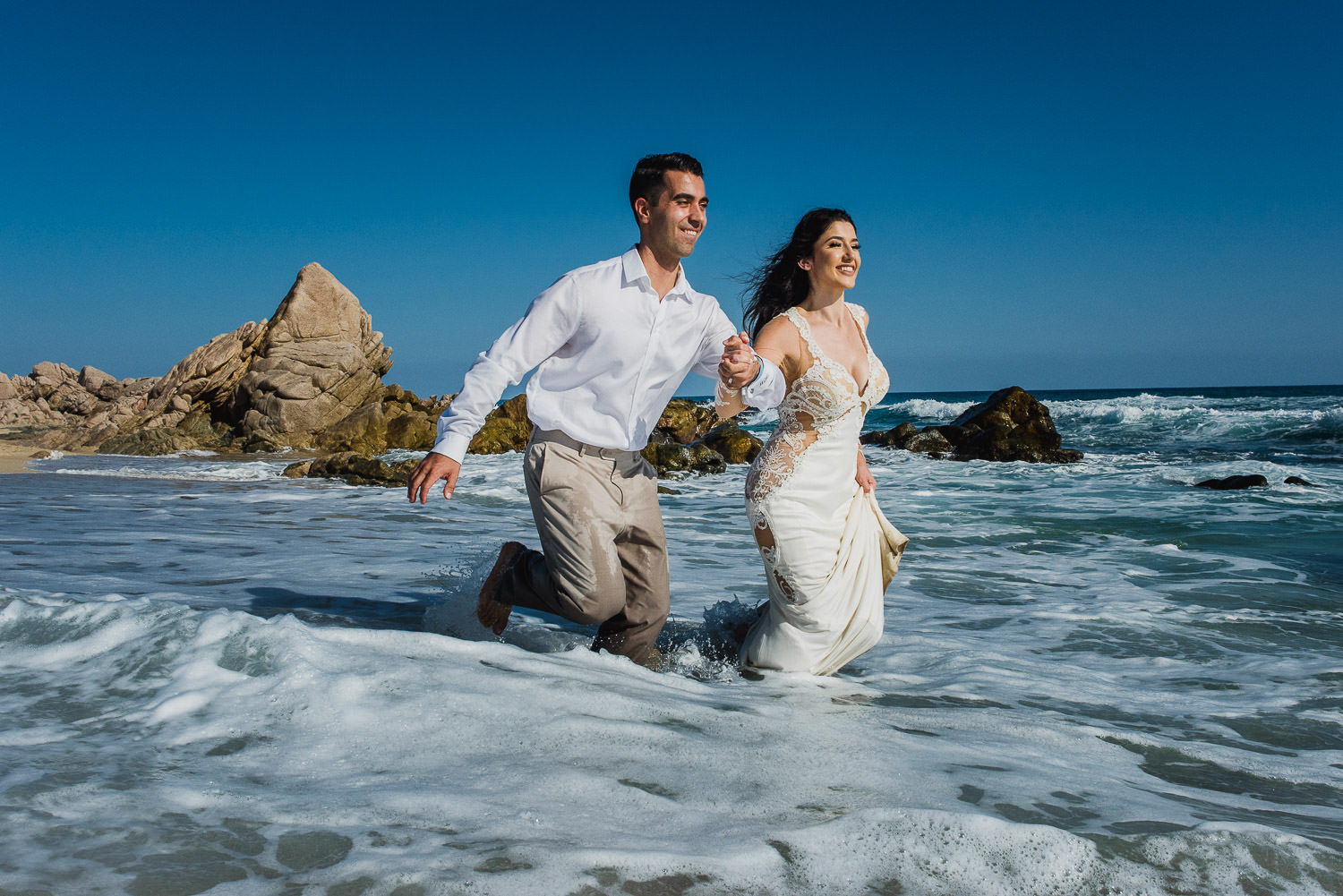 bride and groom having fun on the Ocean