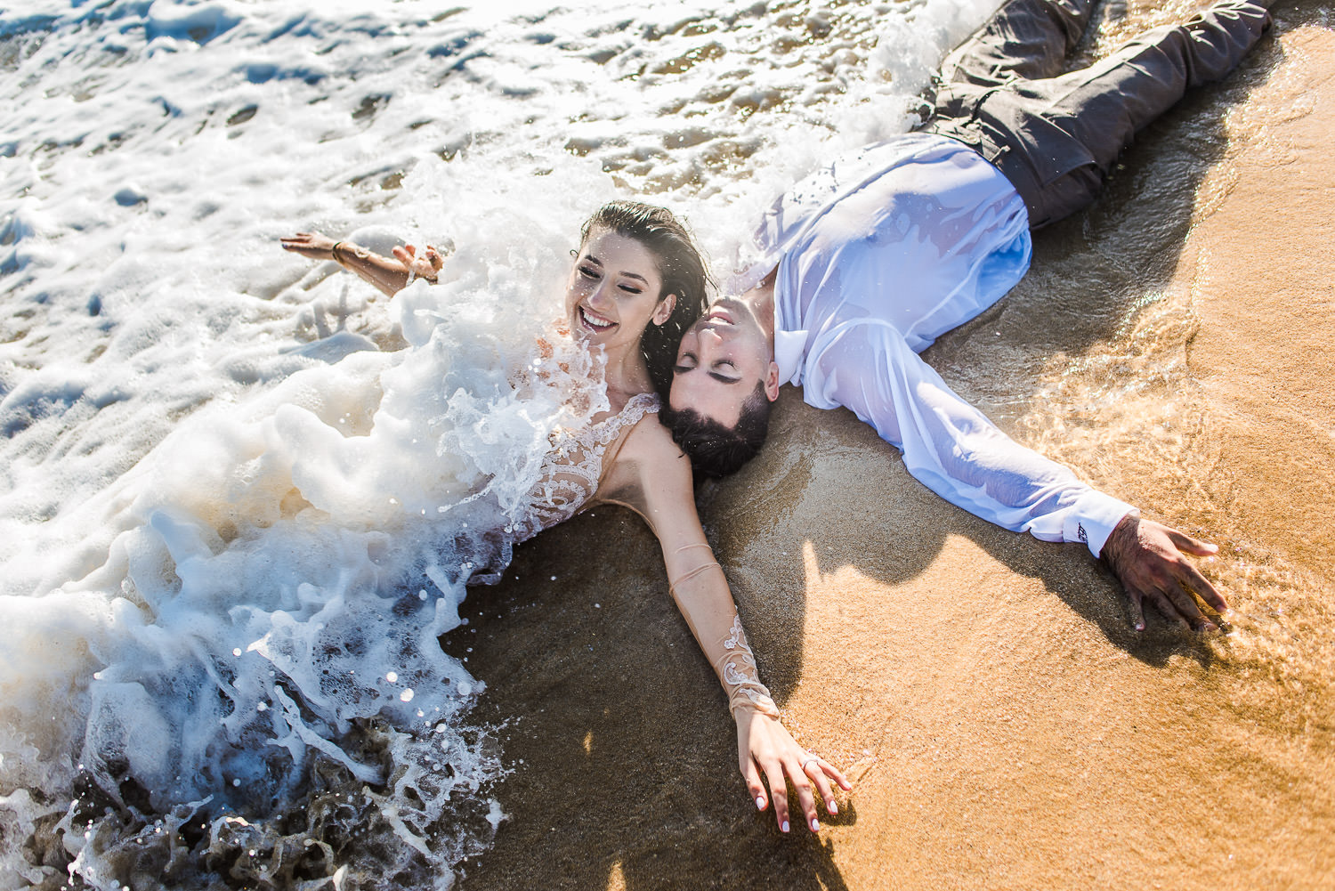 bride and groom having fun with the Ocean