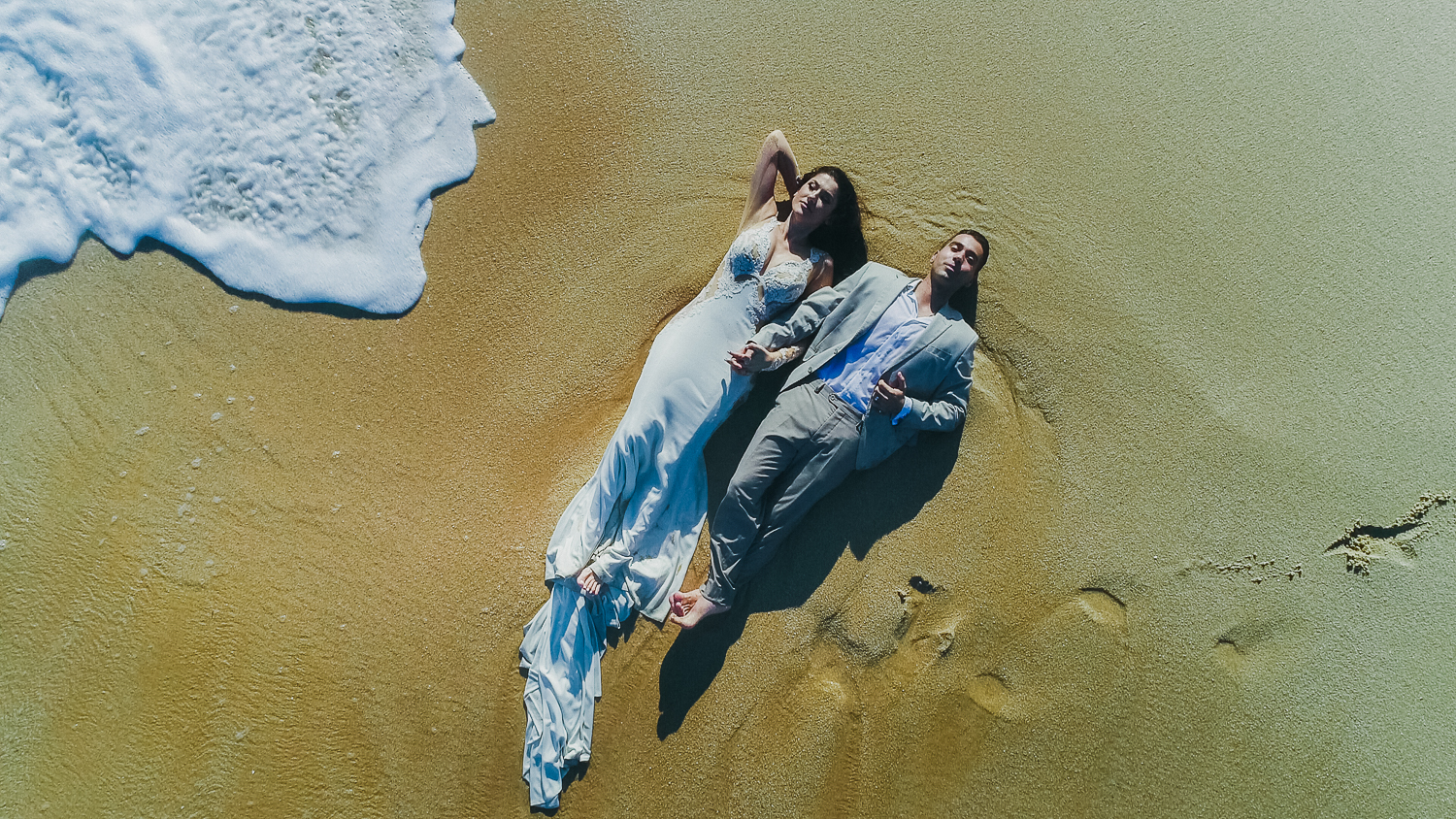 bride and groom aerial shoot at the beach