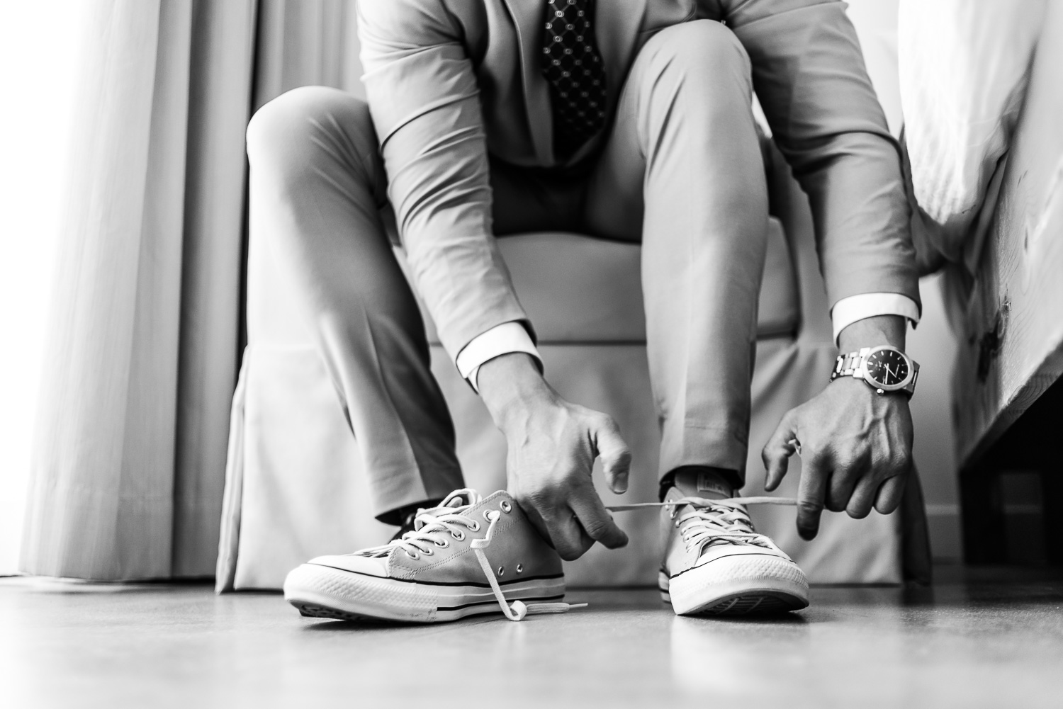  Groom is getting ready at his wedding day, Here you can see final touch of his Converse shoes. GVphotographer is professional destination wedding photographer based in Cabo San Lucas, Mexico 
