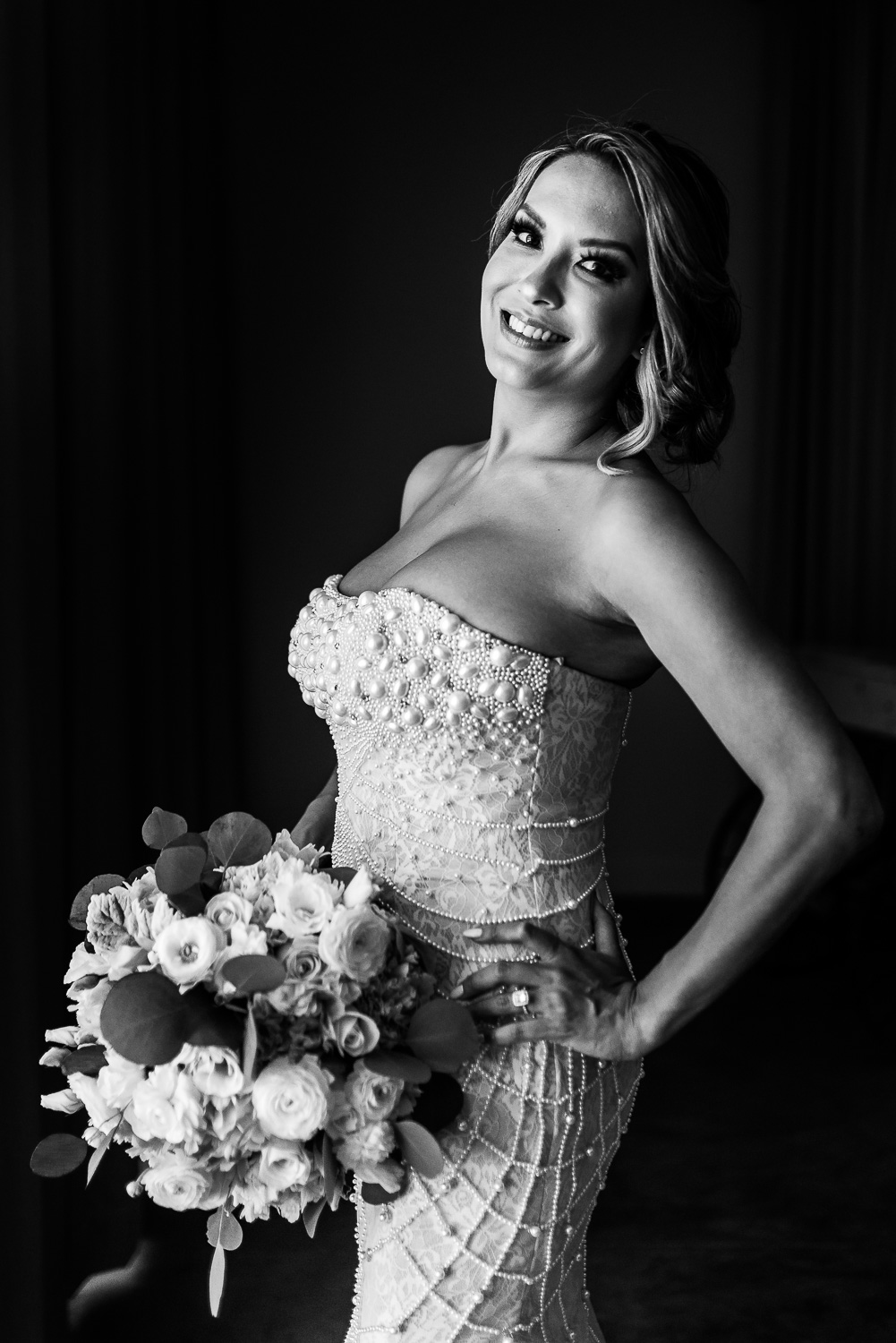  The bride is looking fabulous in her white gown and is smiling. She is holding her wedding bouquet  while  posing for the camera- destination wedding of the wonderful couple Cije and Jose at the beautiful El Ganzo Hotel, Mexico. GVphotographer is an