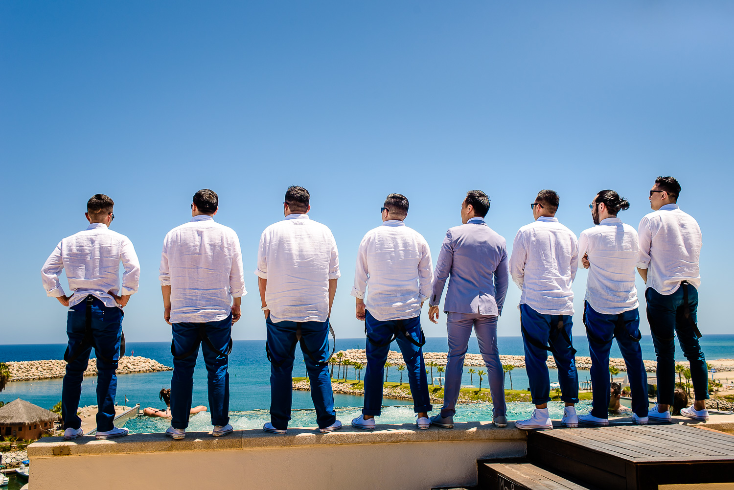  Groom with his friends are looking stunning wearing blue pants and white shirts, everybody is looking to the ocean destination wedding of the wonderful couple Cije and Jose at the beautiful El Ganzo, Mexico. GVphotographer is an amazing destination 