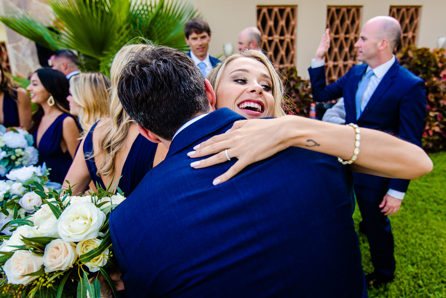  Bride hugging her friends right after the ceremony at Pueblo Bonito Sunset Beach Los Cabos. GVphotographer is an amazing Los Cabos destination wedding photographer 