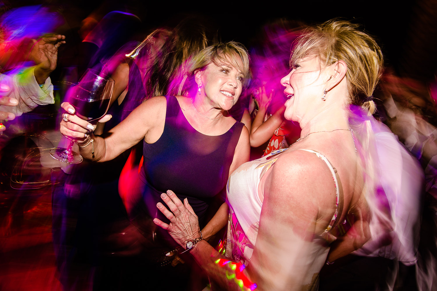  Mother of the bride and a friend are  enjoying the evening party at the dance fllor . Other guests are also dancing on the dance floor at the party- destination wedding of the wonderful couple Chelsea and Jay at the beautiful Pueblo Bonito Sunset Be