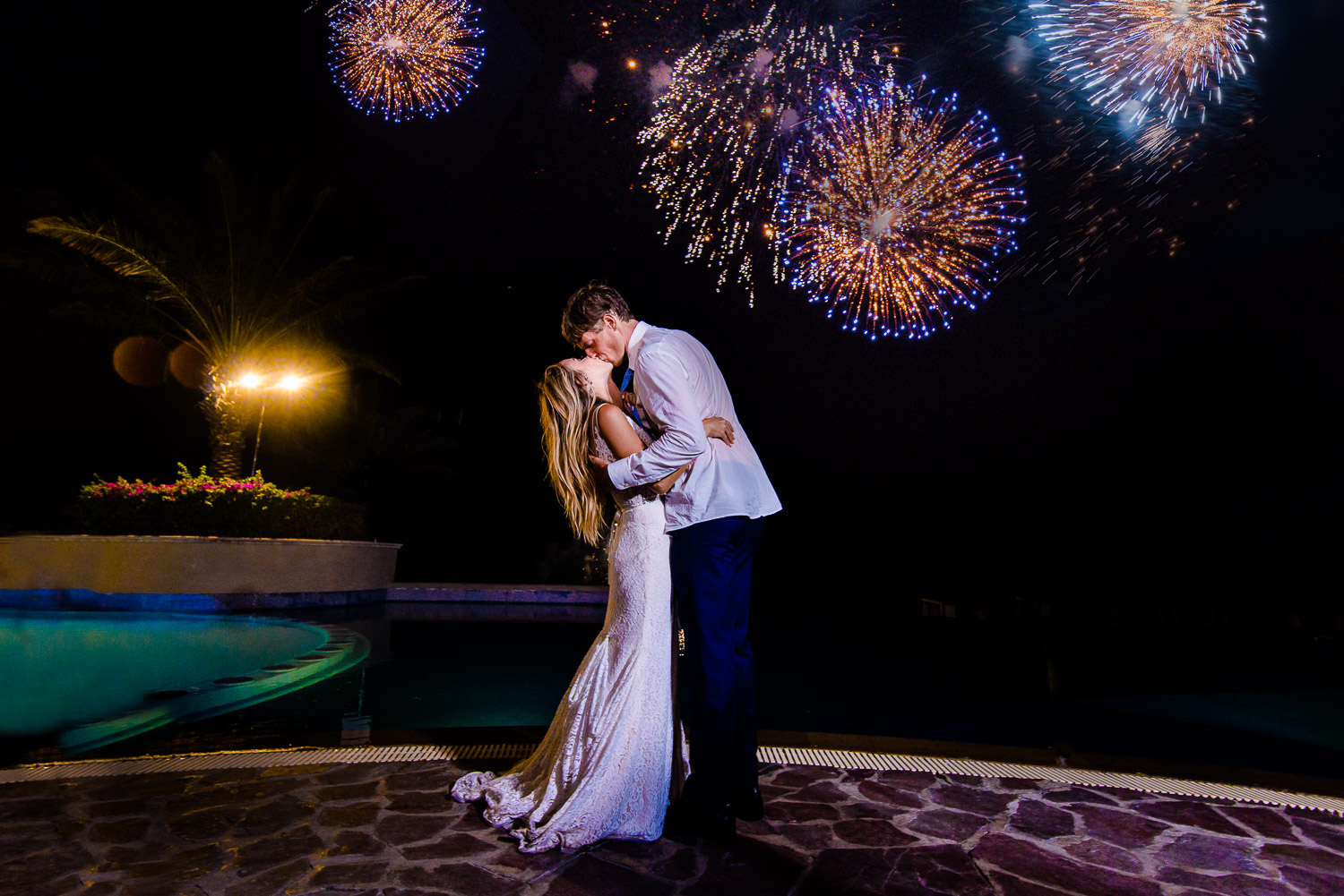  Bride and Groom kissing at their amazing fire works at the Pueblo Bonito Sunset Beach Skypool during Chelsea and Jay destination wedding. GVphotographer is an amazing destination wedding photographer based in Cabo San Lucas, Mexico 