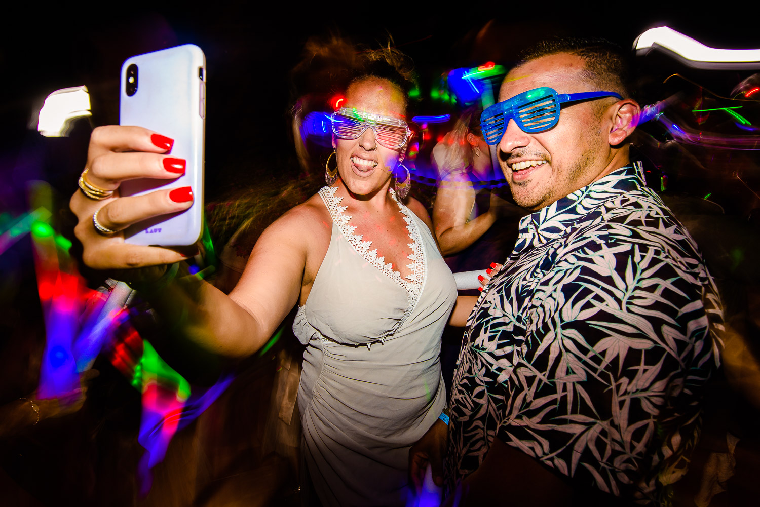  A beautiful couple selfie on the dance floor. Both wearing glasses made of glow bands and is dancing with full energy at the evening party of the lovely couple-destination wedding of the wonderful couple Chelsea and Jay at the beautiful Pueblo Bonit