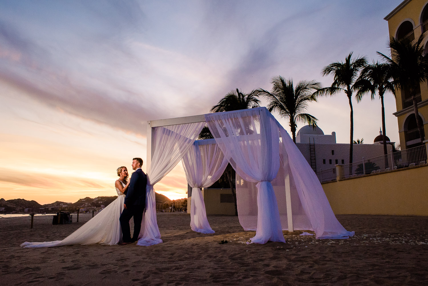 bride and groom during their sunset photo session at Riu Palce Cabo san Lucas