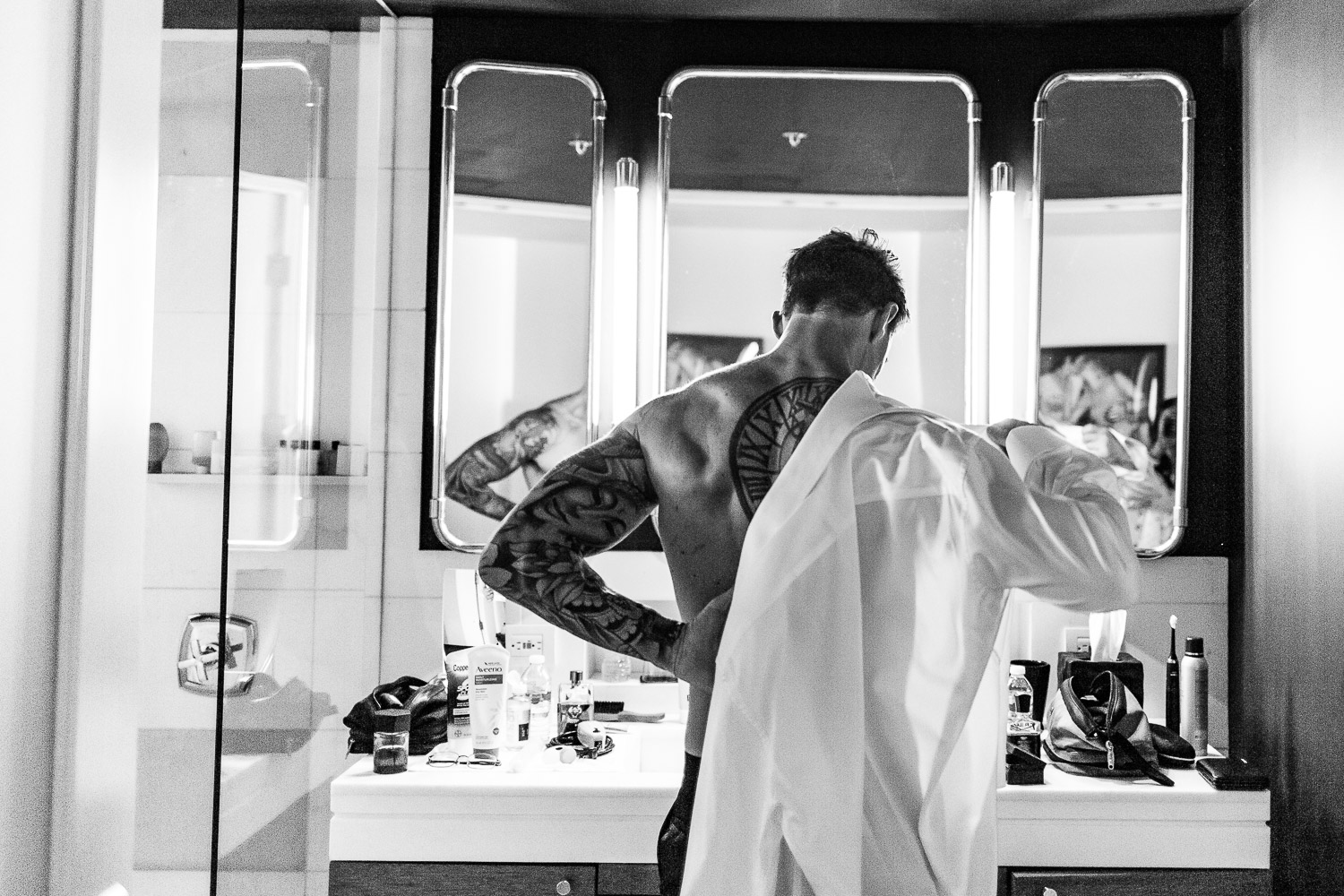 Groom getting ready in fron of the mirror (Copy)