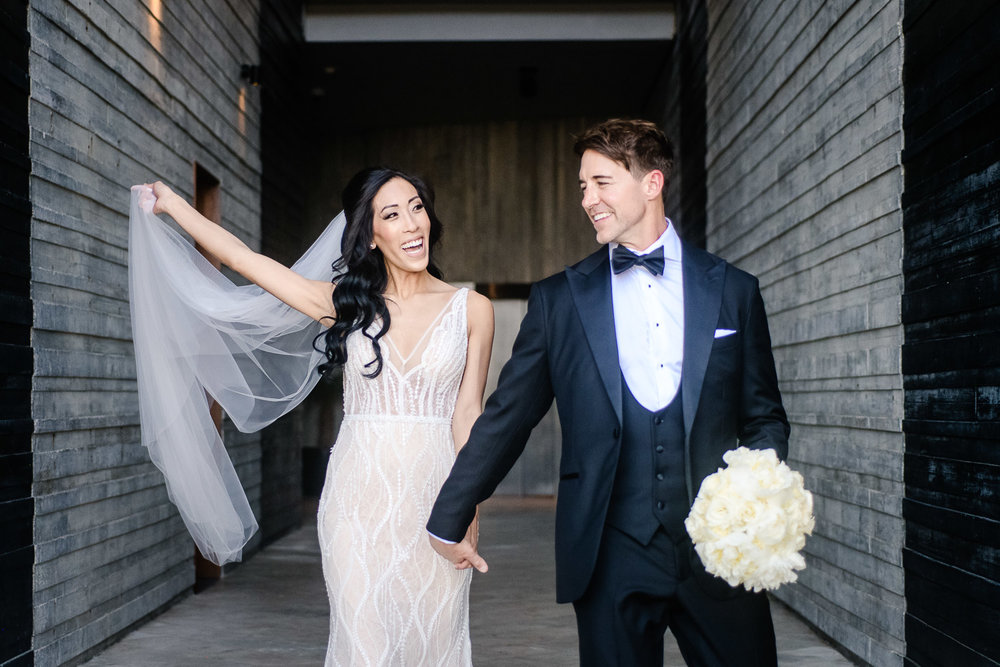 Bride and groom walking and having fun on their Los Cabos photo session