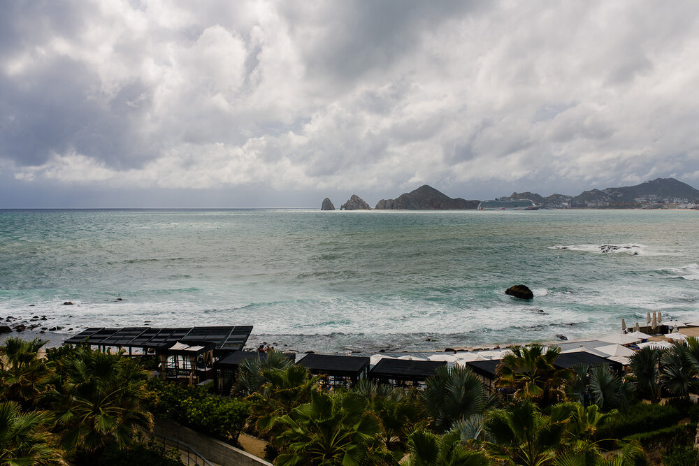 Aerial view of a rainy day at The Cape Los Cabos. Palm trees, the ocean, te famous Arch and lot of clouds