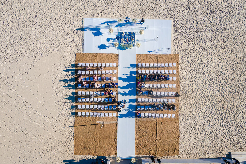 Wedding reception ceremony setup on the beach, aerial view