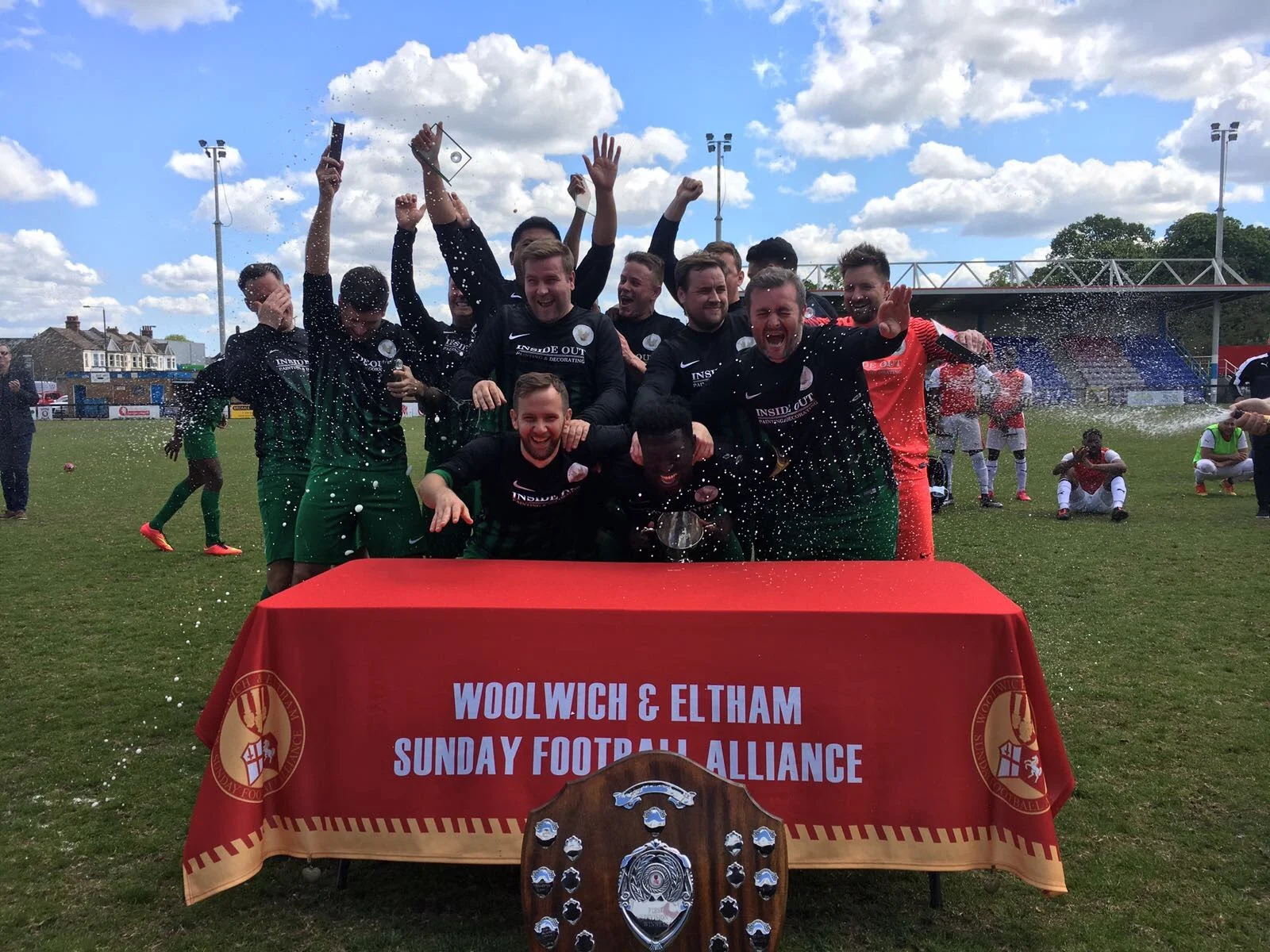 Woodside Celtic lift the Alliance Cup, with the Division One shield in the foreground
