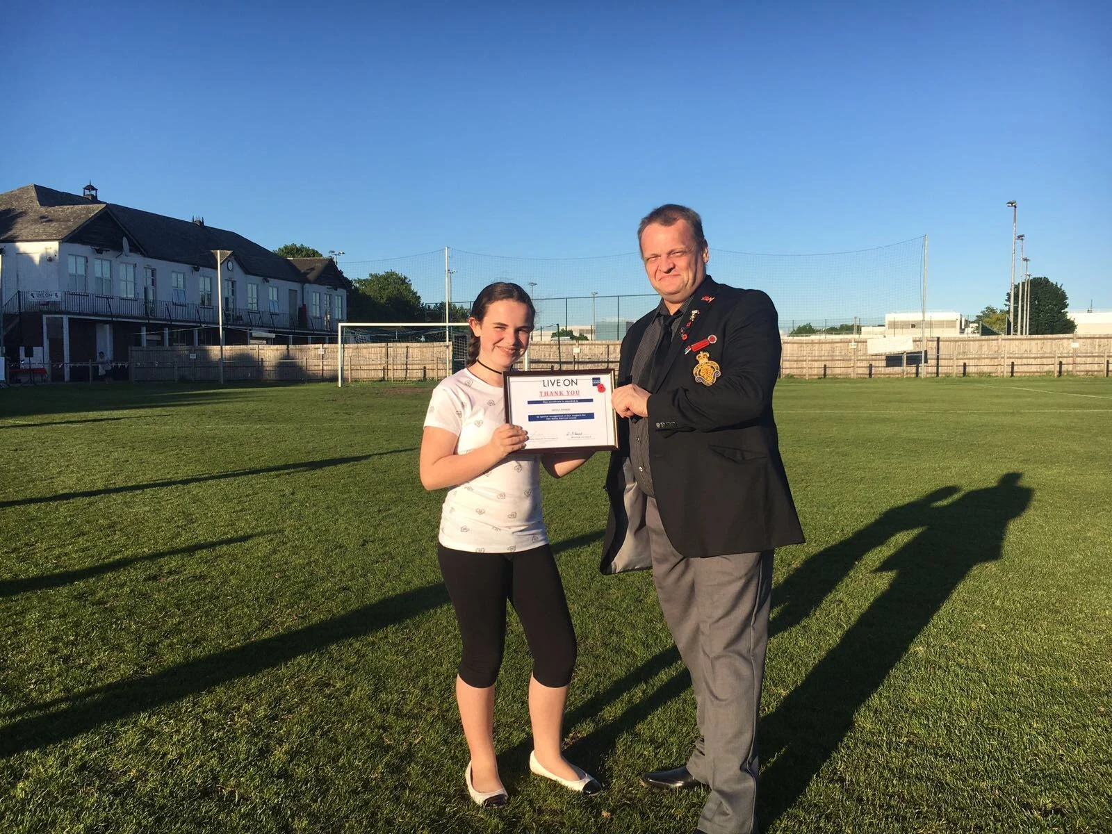 Nicole Hooker receives her reward from Graham Seaward of the Royal British Legion