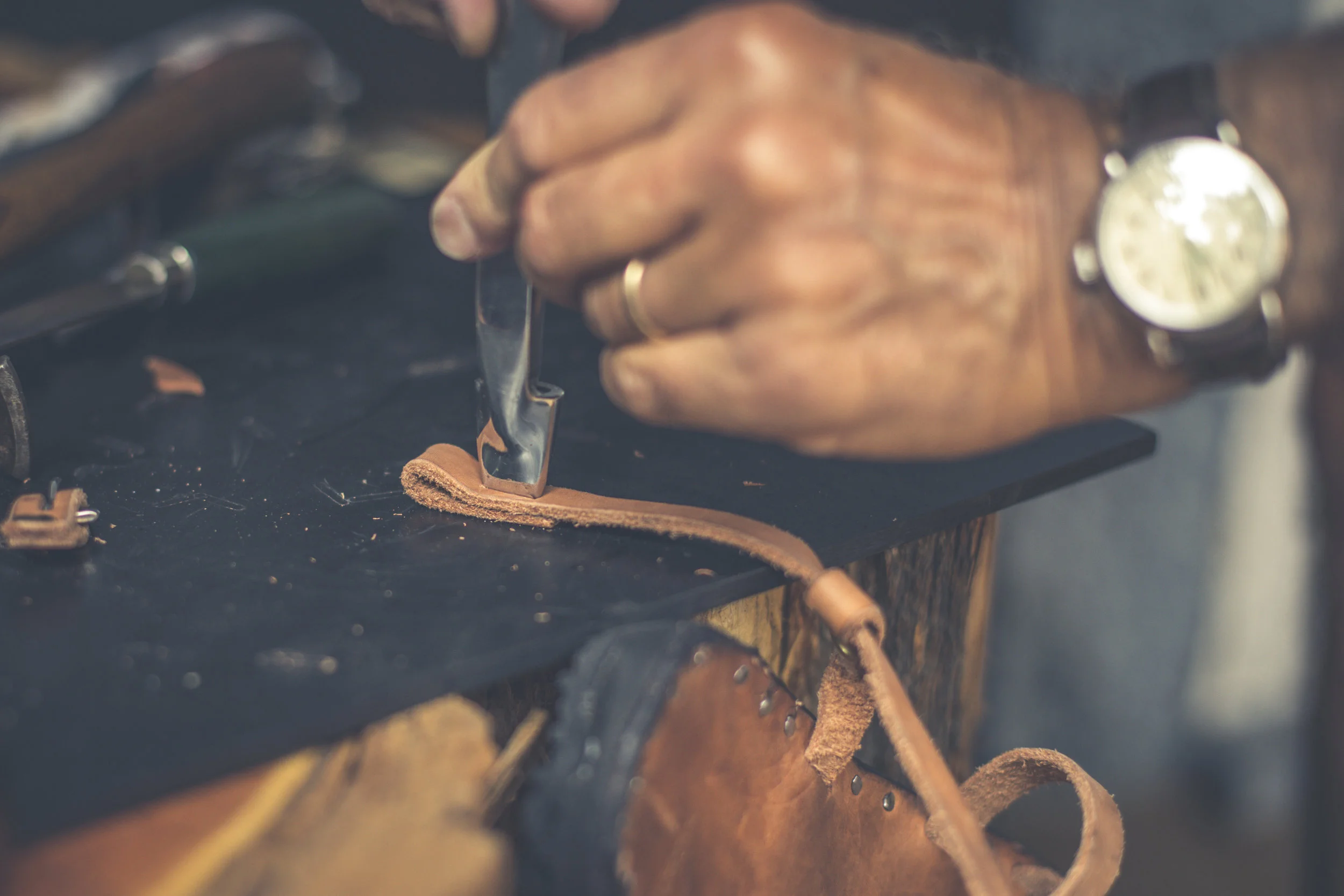 Punching the hole where the buckle will go.