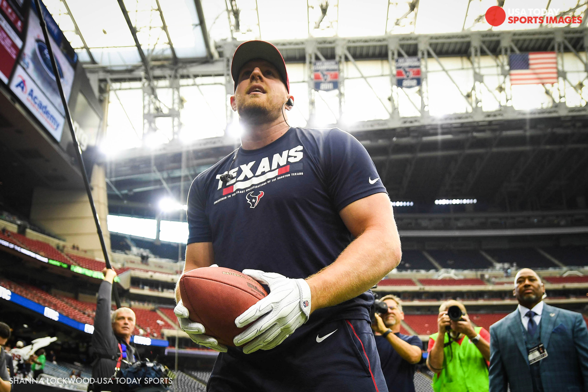 J.J. Watt tosses the football to fans in the stands before the game against the Jaguars.
