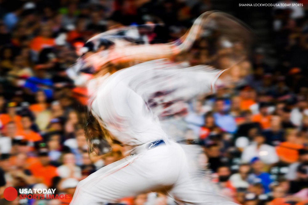  May 22, 2018; Houston, TX, USA; (Editor's Note: Slow-shutter photo.) Houston Astros starting pitcher Gerrit Cole (45) delivers a pitch during the sixth inning against the San Francisco Giants at Minute Maid Park. Mandatory Credit: Shanna Lockwood-US
