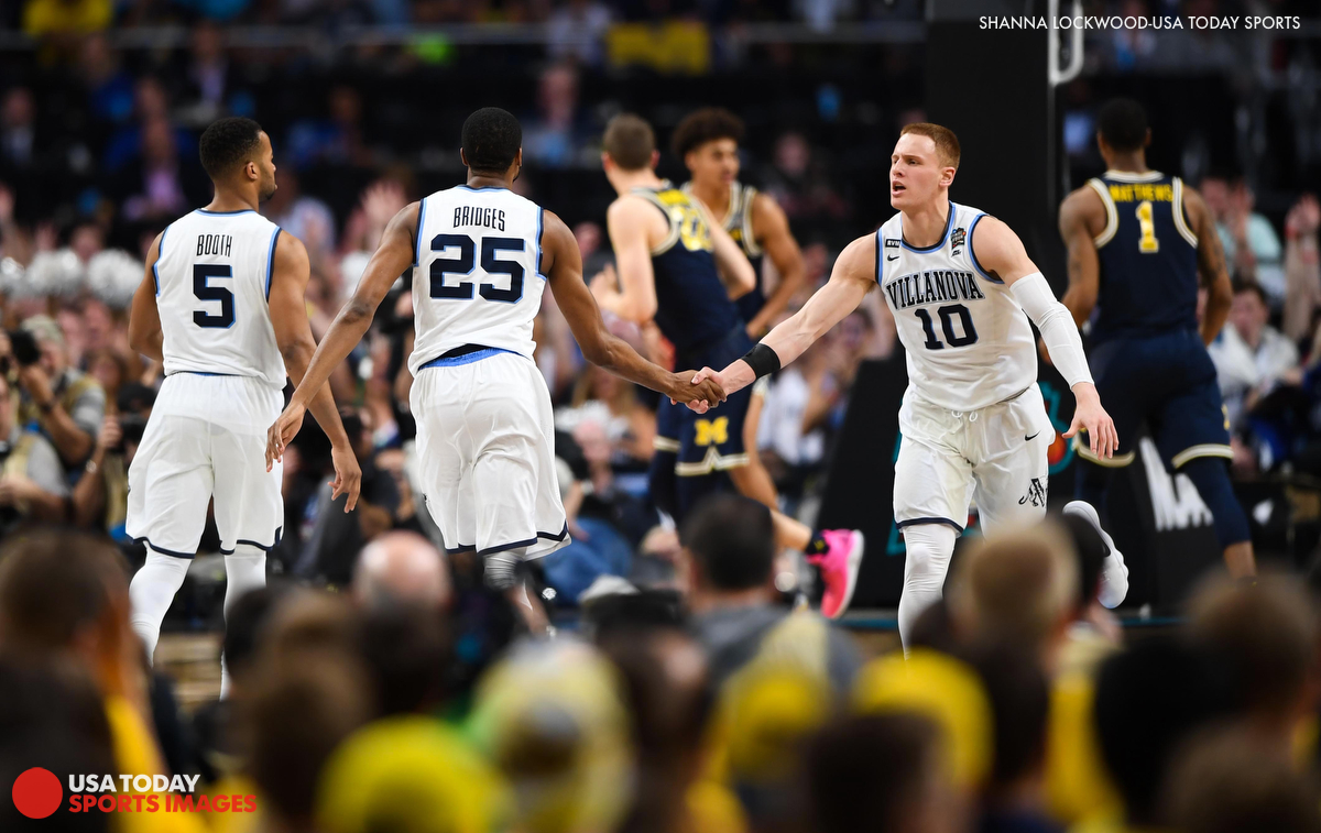  Apr 2, 2018; San Antonio, TX, USA; Villanova Wildcats guard Donte DiVincenzo (10) celebrates with guard Mikal Bridges (25) and guard Phil Booth (5) in the second half against the Michigan Wolverines in the championship game of the 2018 men's Final F