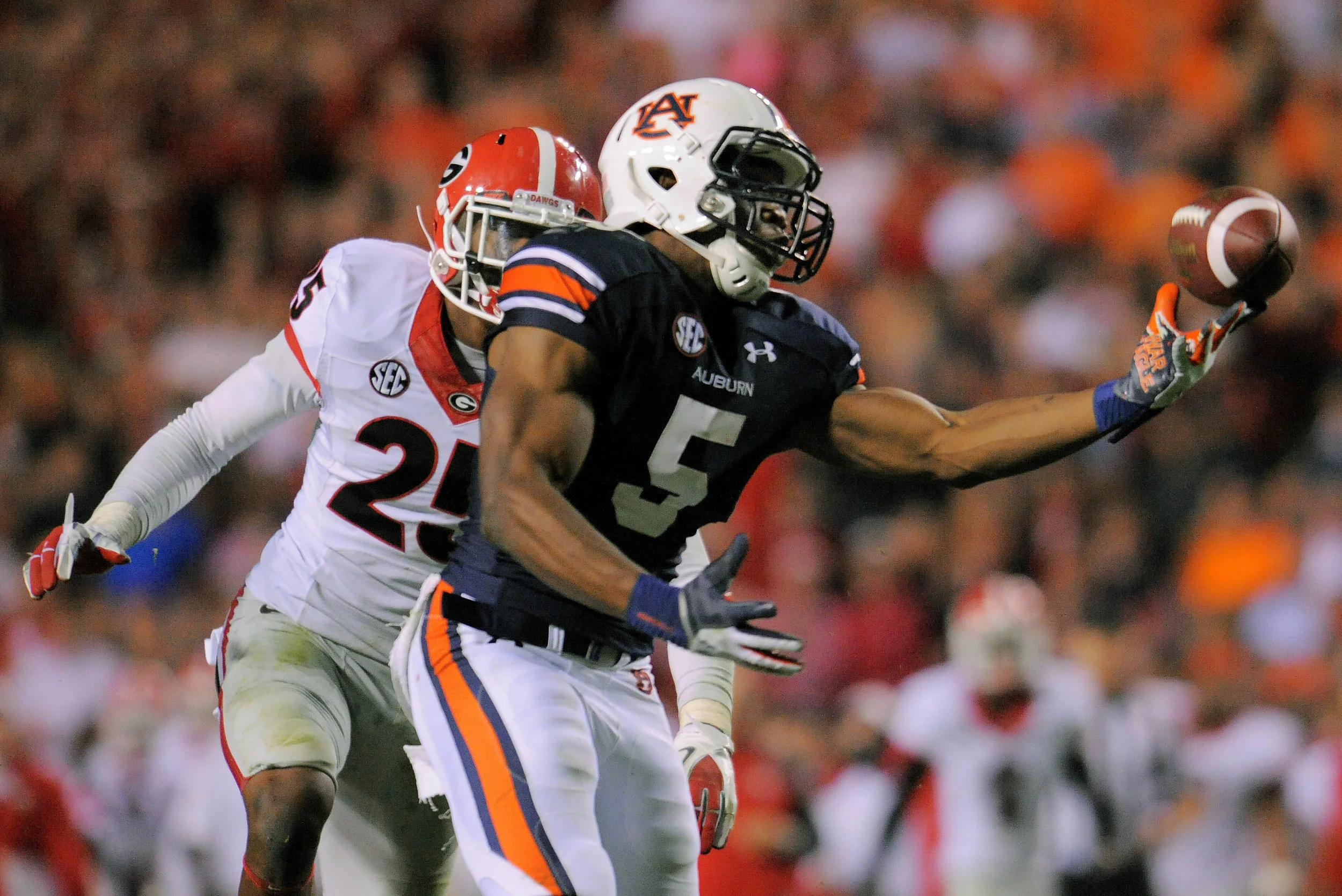 Nov 16, 2013; Auburn, AL, USA; Auburn Tigers wide receiver Ricardo Louis (5) catches a tipped ball by Georgia Bulldogs defensive back Josh Harvey-Clemons (25) and scores the game winning touchdown at Jordan Hare Stadium. The Tigers defeated the Bulldogs 43-38. Mandatory Credit: Shanna Lockwood-USA TODAY Sports