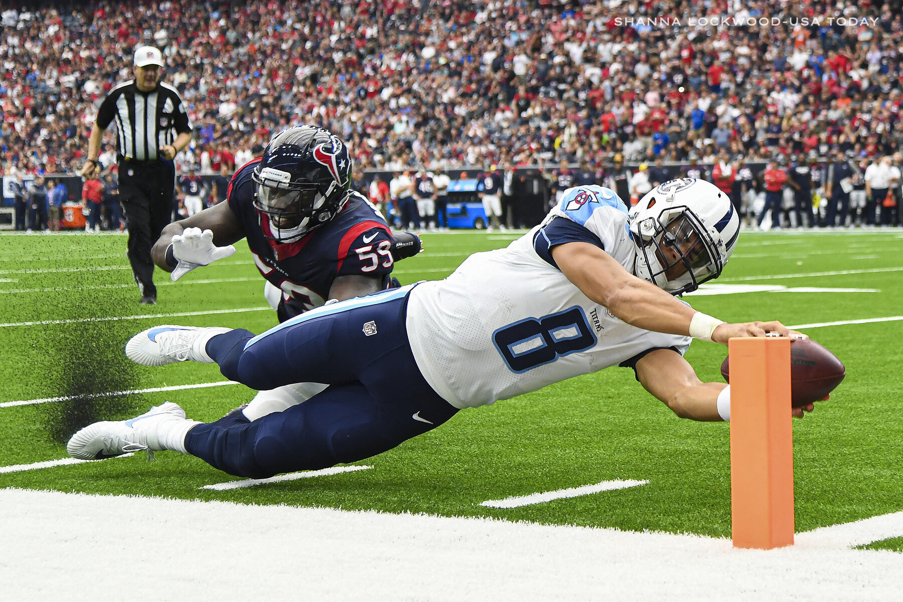  Oct 1, 2017; Houston, TX, USA; Tennessee Titans quarterback Marcus Mariota (8) scores a touchdown ahead of Houston Texans outside linebacker Whitney Mercilus (59) during the second quarter at NRG Stadium. Mandatory Credit: Shanna Lockwood-USA TODAY 